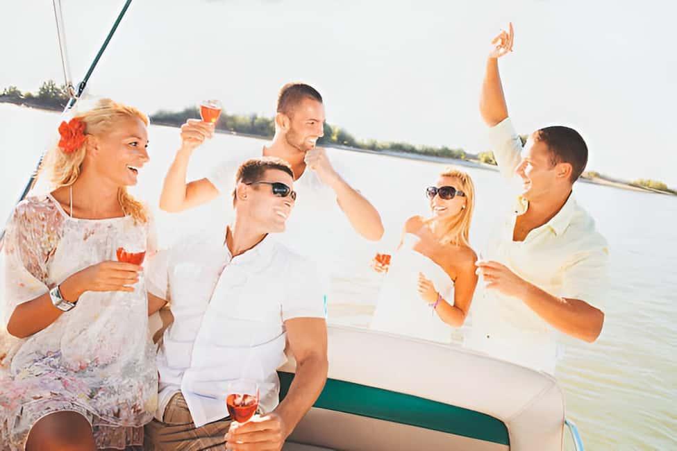 A group of friends celebrating with drinks on a boat on the Red Sea