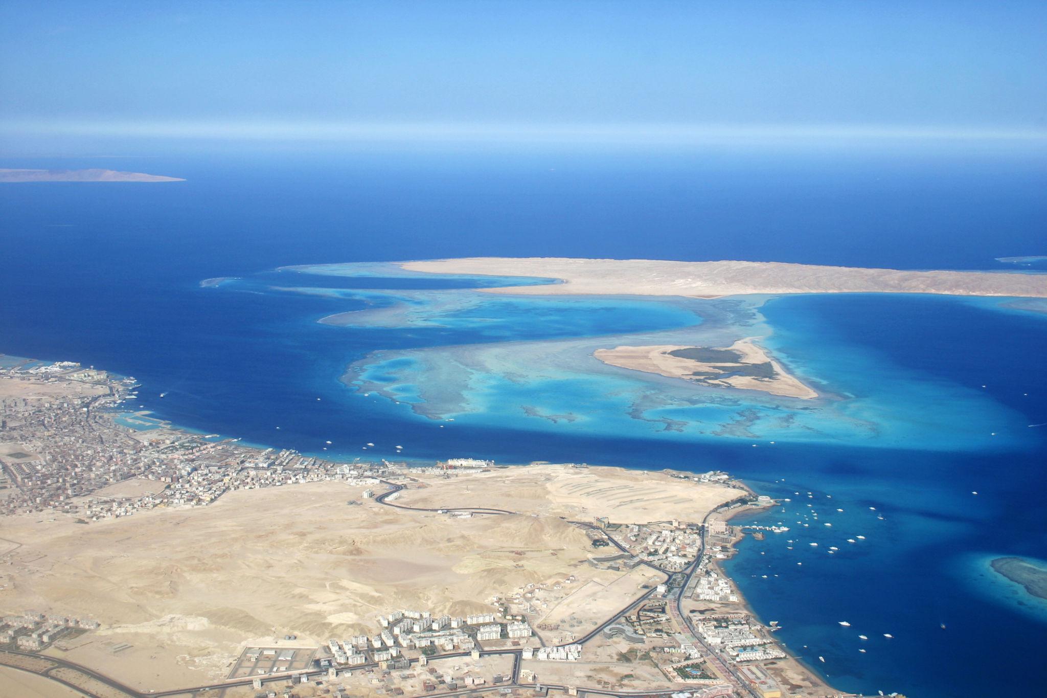 Aerial view of Hurghada coastline with turquoise coral reefs and sandy islands in the Red Sea