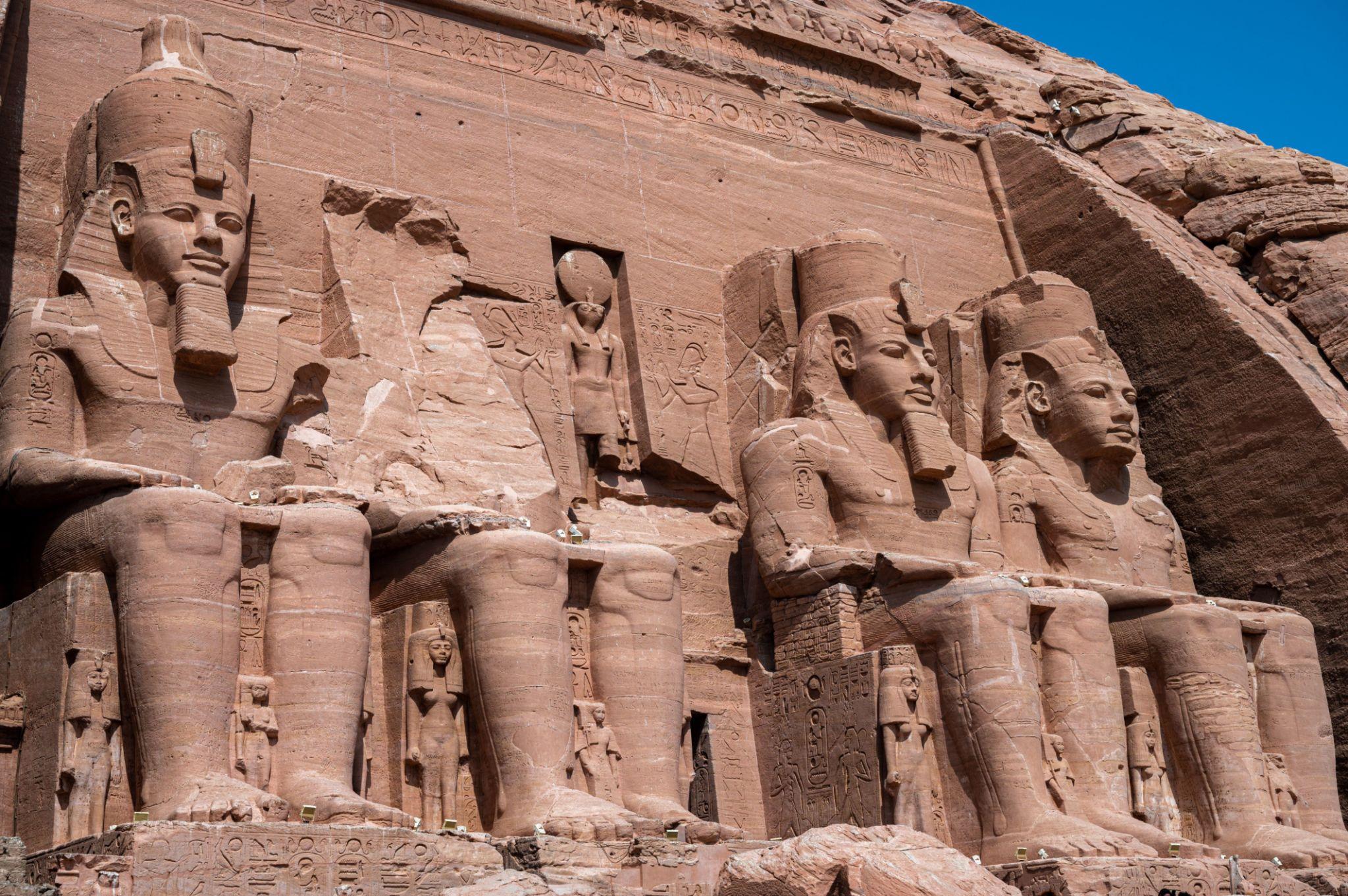 Four massive carved sandstone colossi of Ramesses II at the Abu Simbel temple facade
