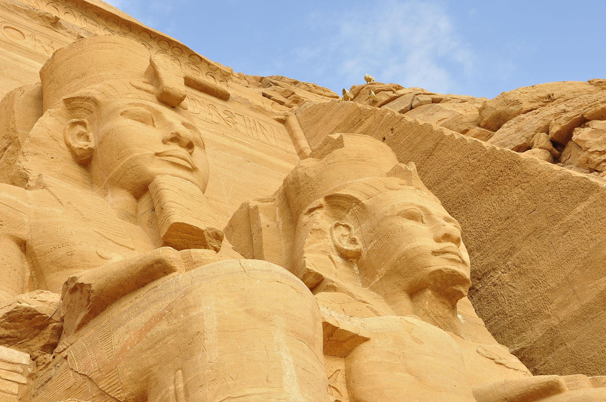 Two massive carved sandstone colossi of Ramesses II at the Abu Simbel temple facade