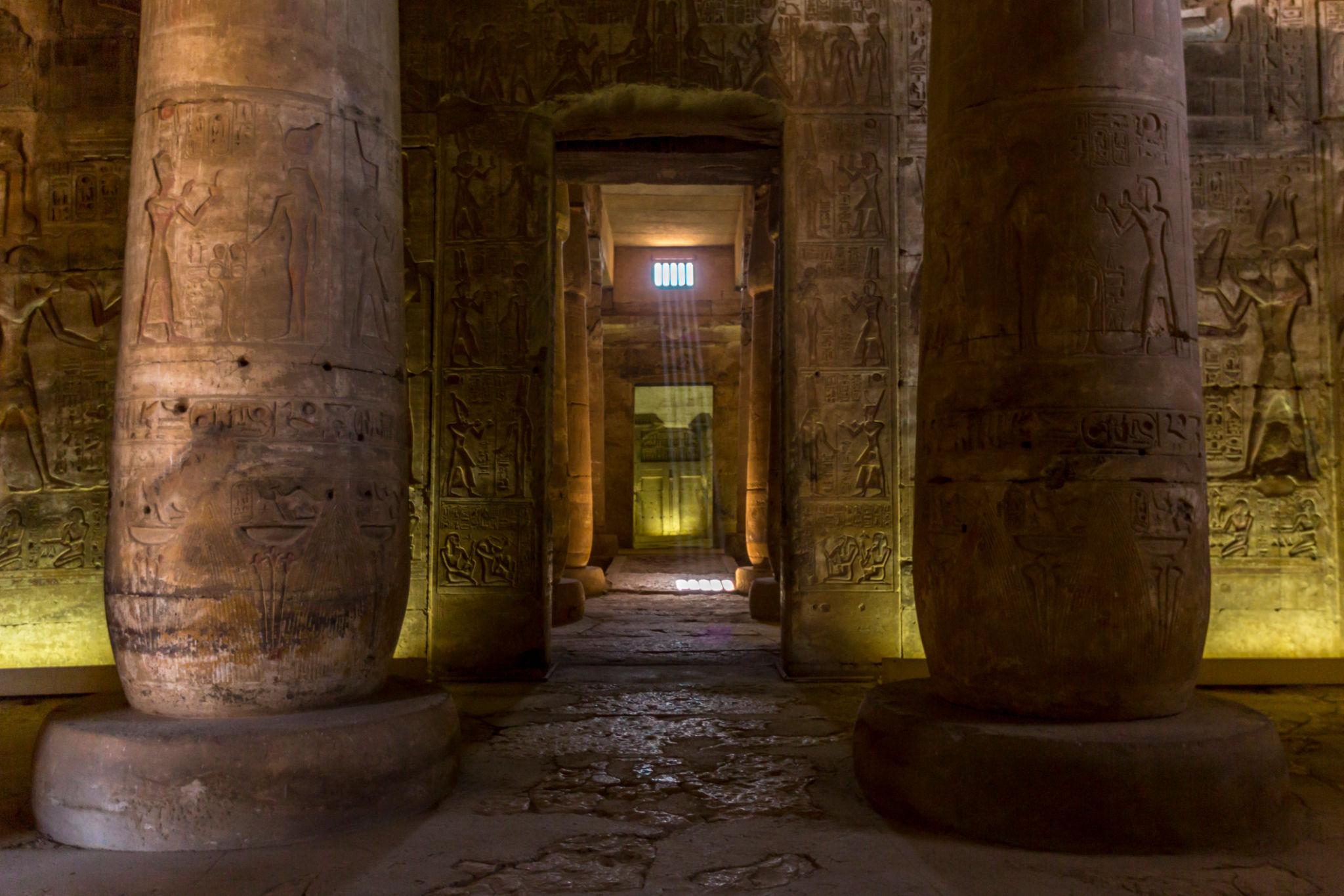 Light shaft illuminating a carved sanctuary doorway at the Temple of Seti I.