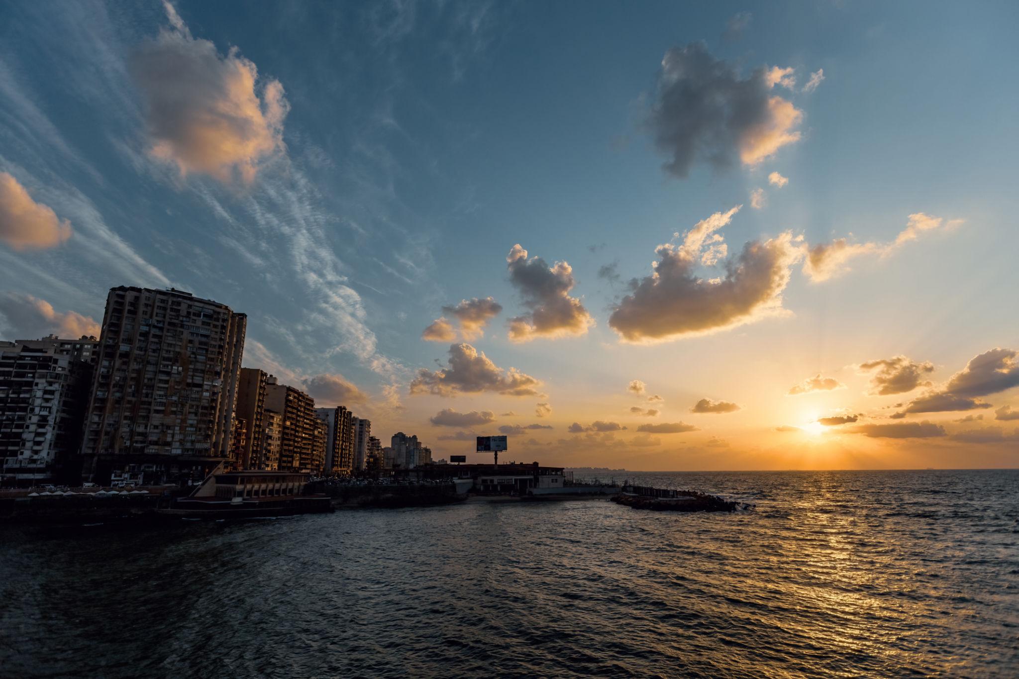 Golden Mediterranean sunset over the sea with Alexandria Corniche high-rises silhouetted on the left