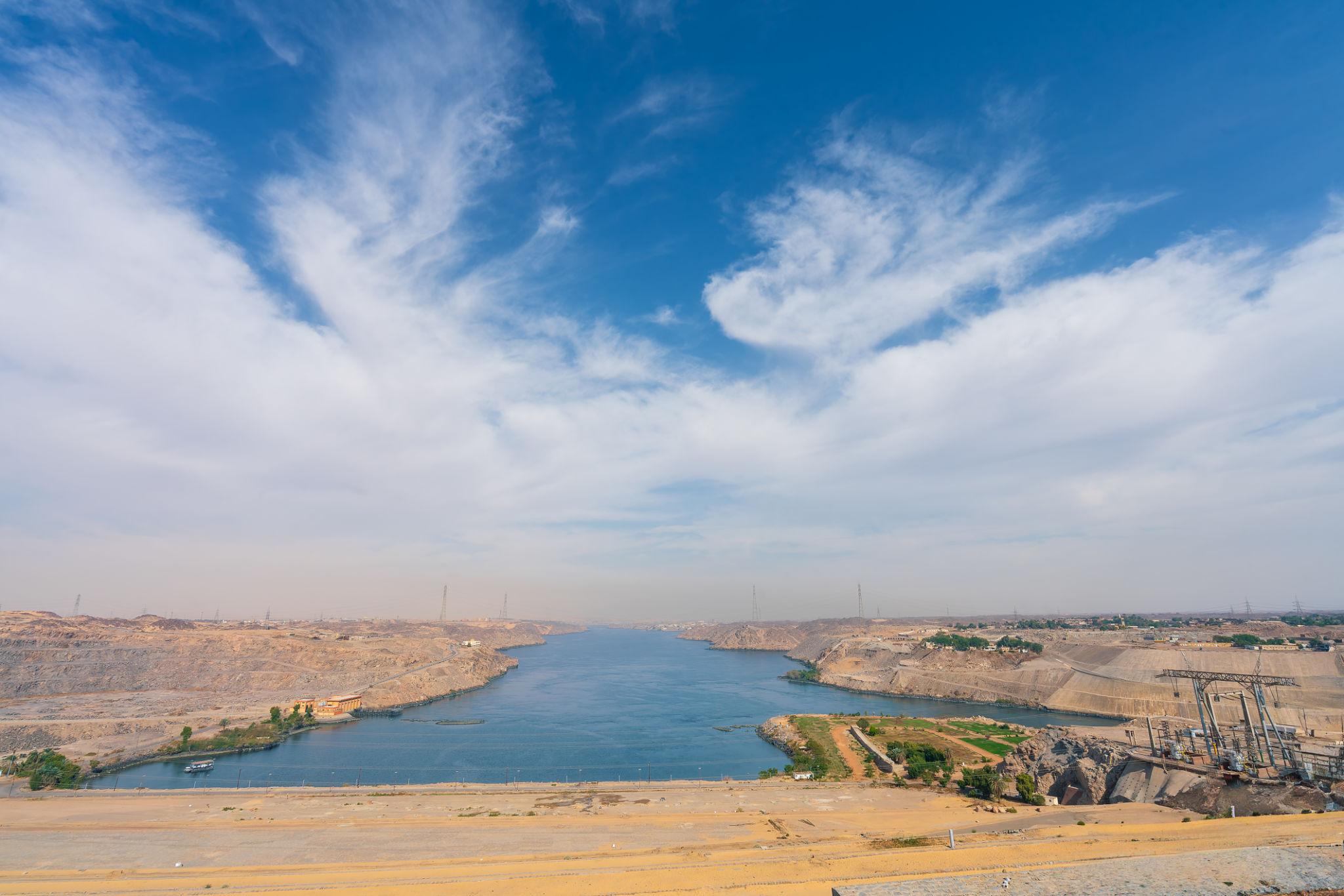 Sweeping vista of the Nile reservoir downstream of Aswan High Dam under blue sky