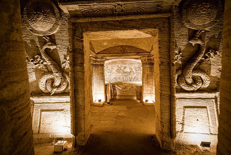Principal tomb doorway flanked by serpent reliefs and Medusa shields in the Alexandria catacombs