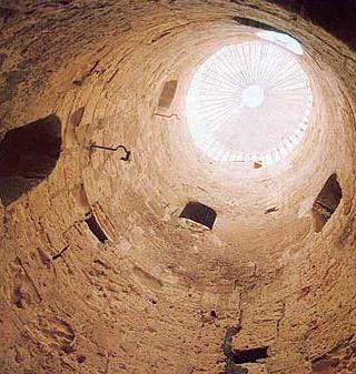 Looking up the open central shaft of the spiral staircase descending into Kom el-Shoqafa