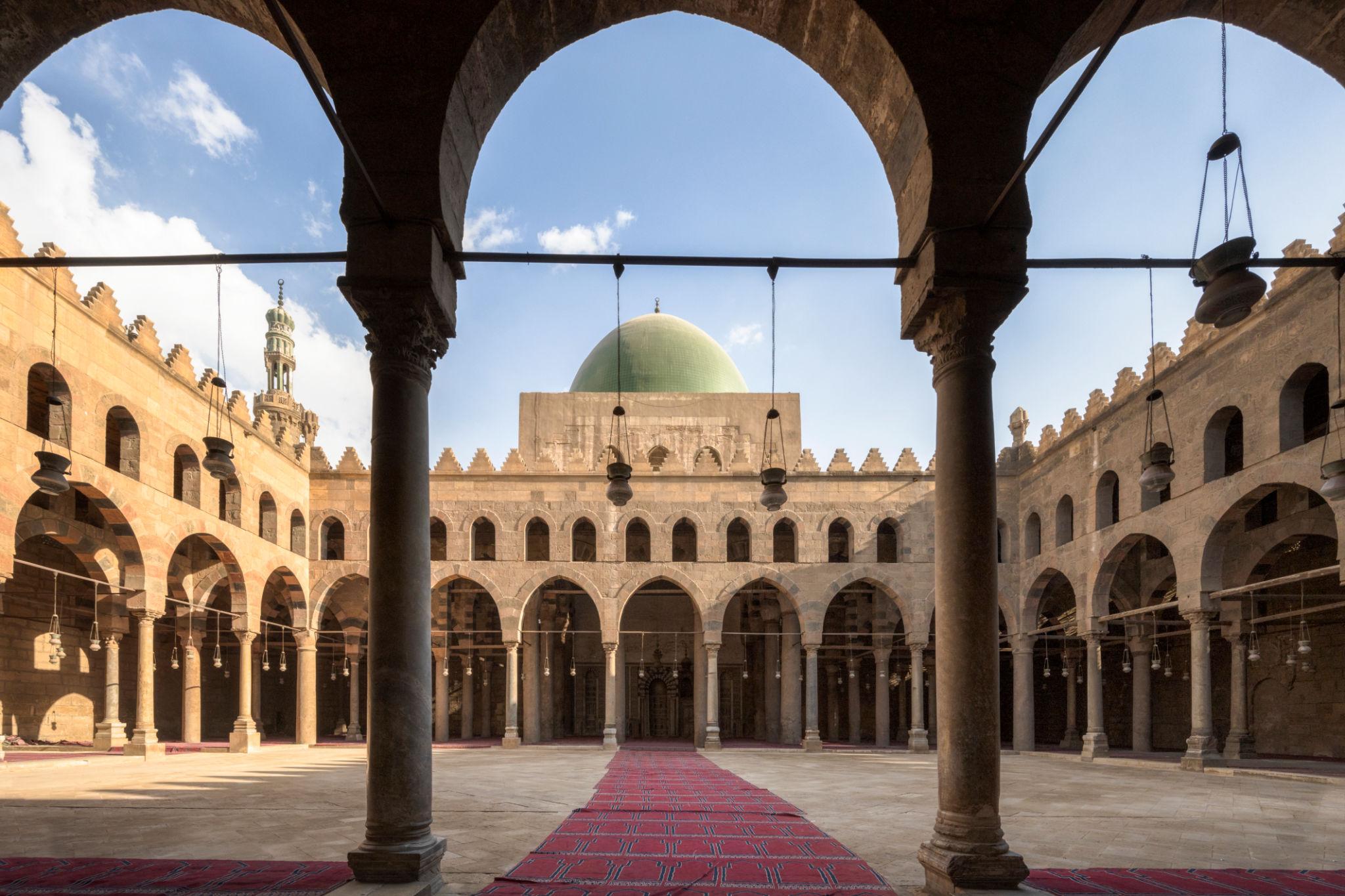 Arched courtyard and green dome of the Al-Nasir Muhammad Mosque inside the Citadel of Saladin