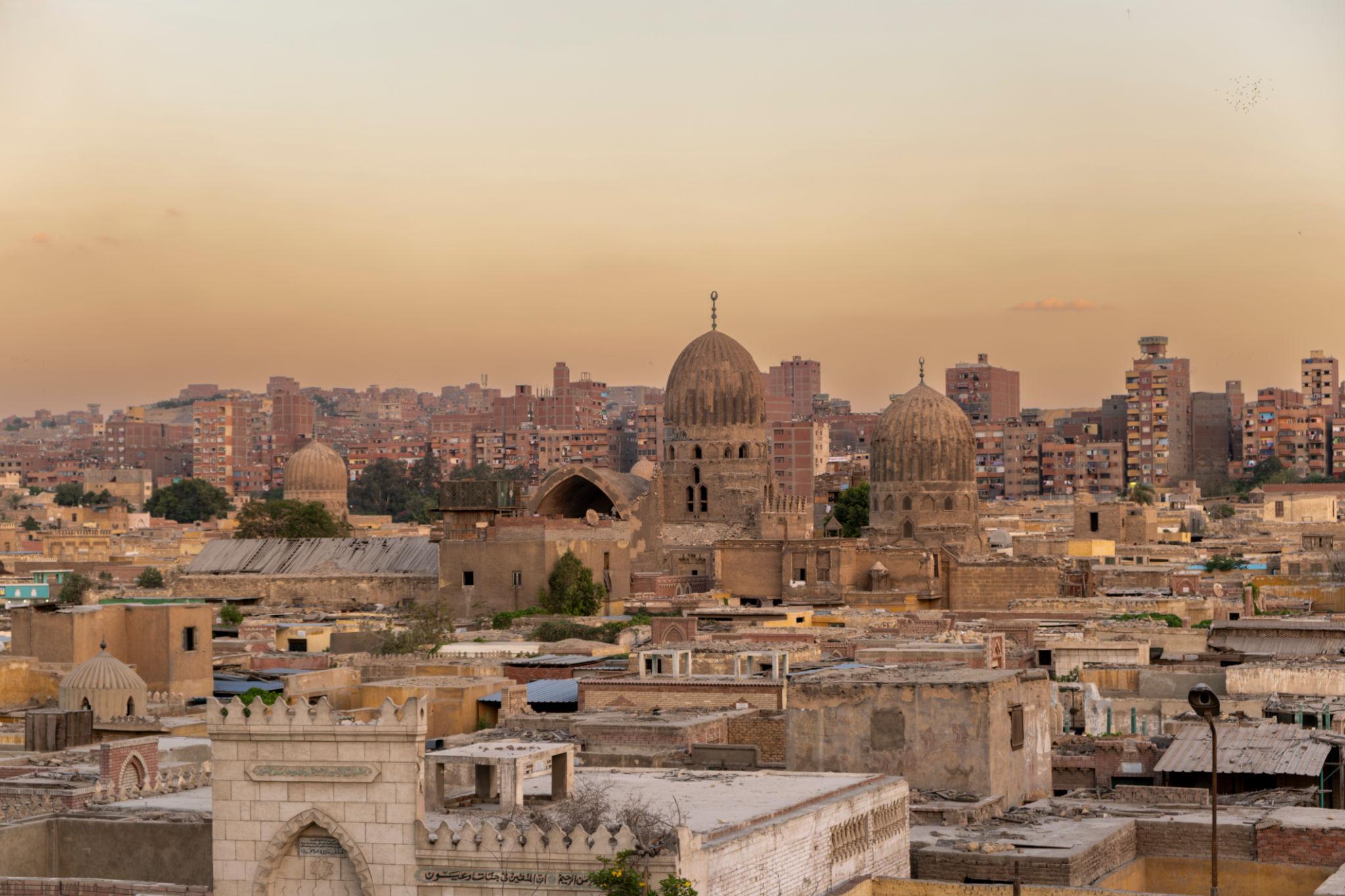 Panoramic sunset view of Mamluk tomb domes and minarets across the Cairo City of the Dead