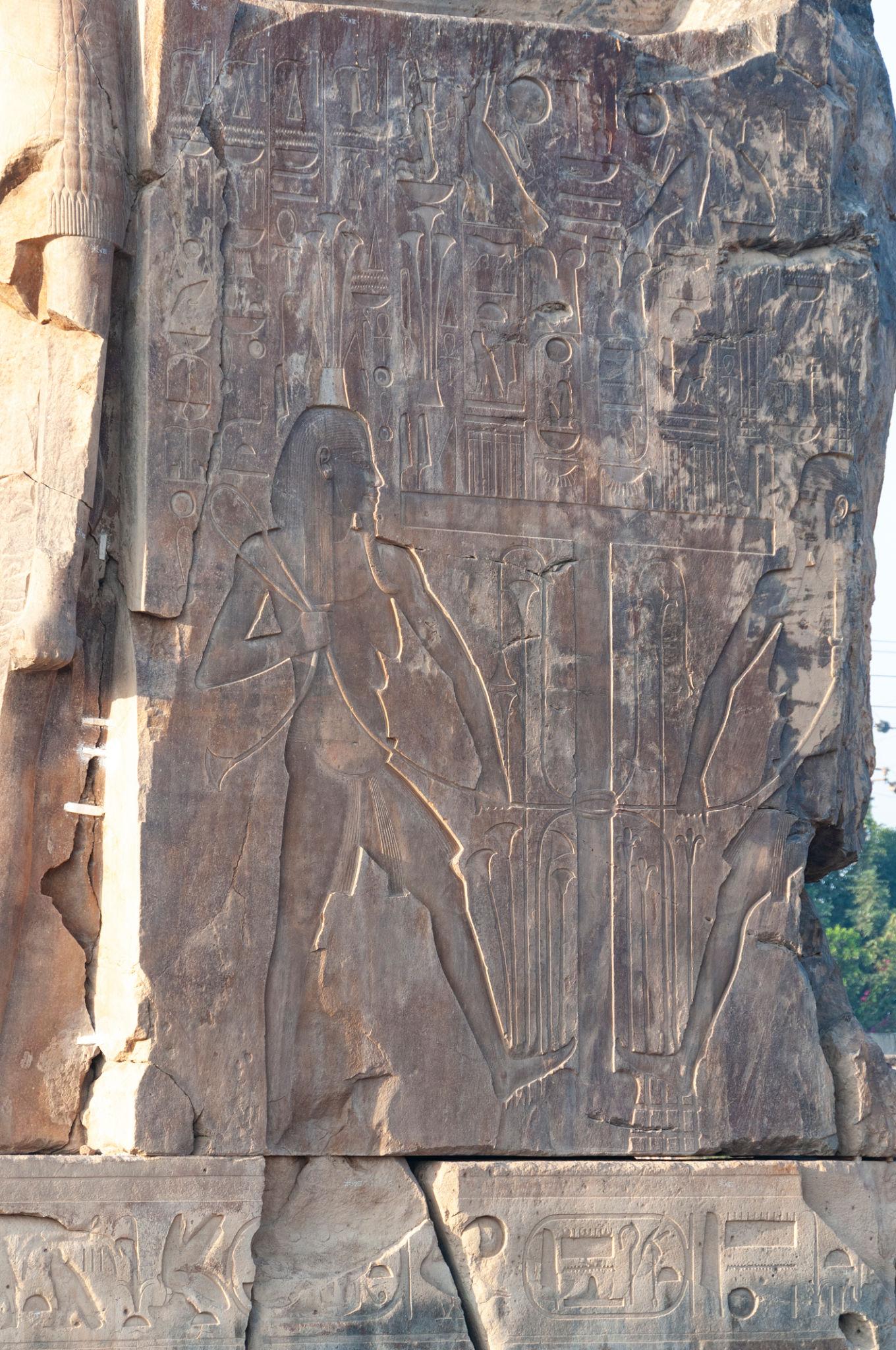 Carved relief on the throne of a Colossus of Memnon showing Nile god figure and hieroglyphs