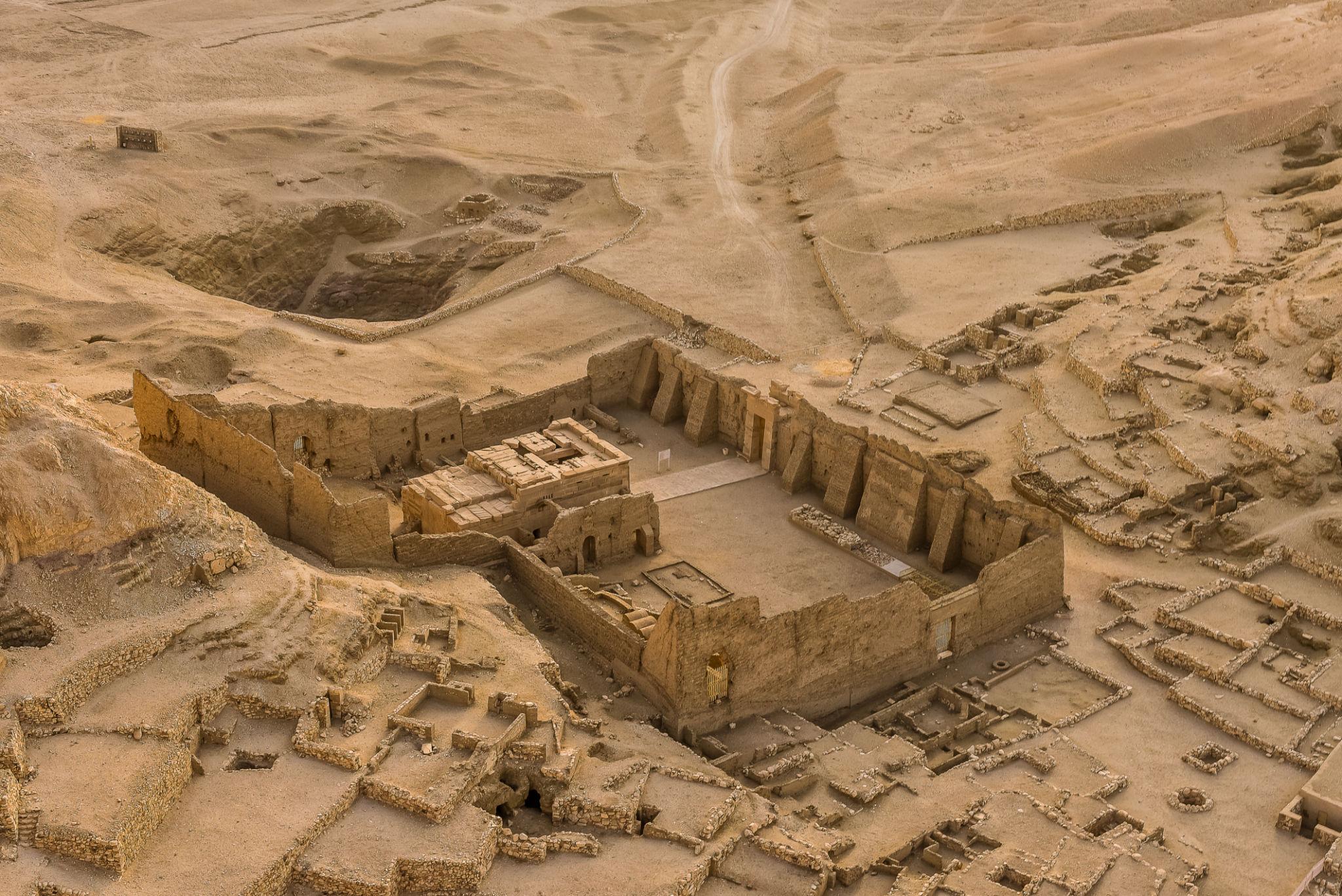 Aerial view of the walled Hathor temple precinct surrounded by ruined artisan houses at Deir el-Medina