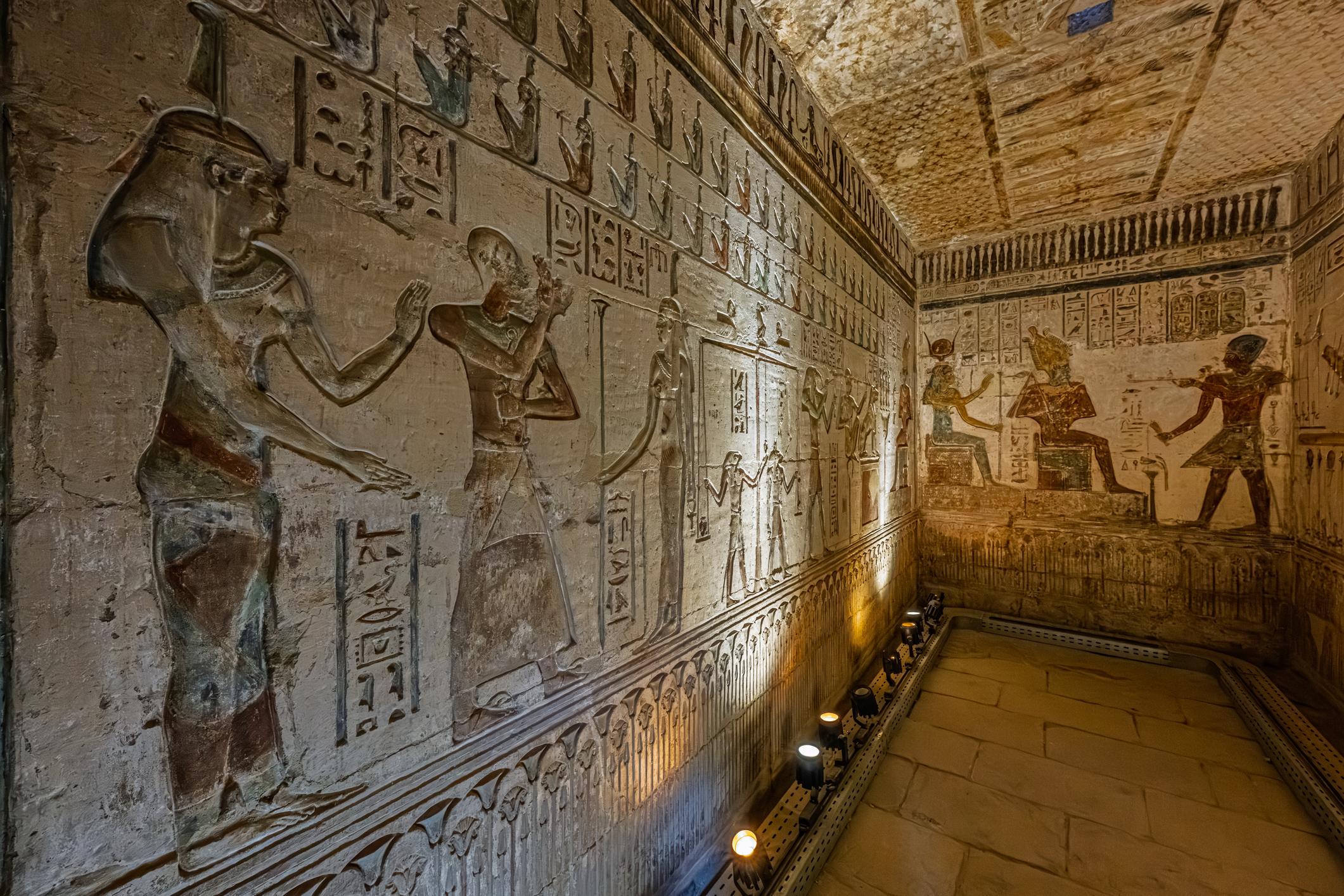 Painted relief corridor in the Hathor temple at Deir el-Medina showing pharaoh making offerings to gods