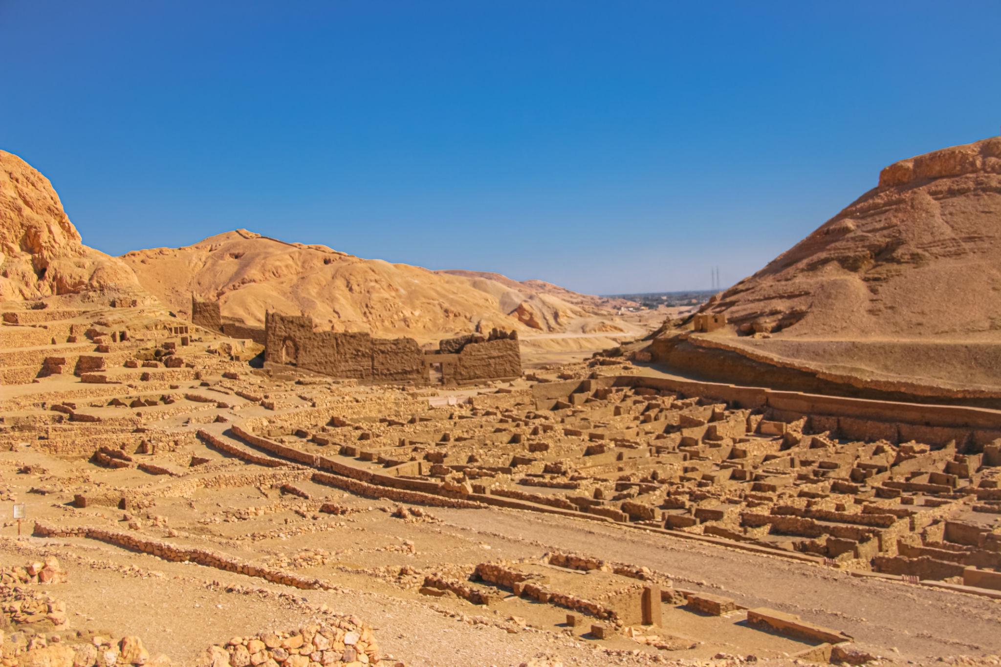 Stone foundations of the Deir el-Medina artisans' village set in the Theban desert valley