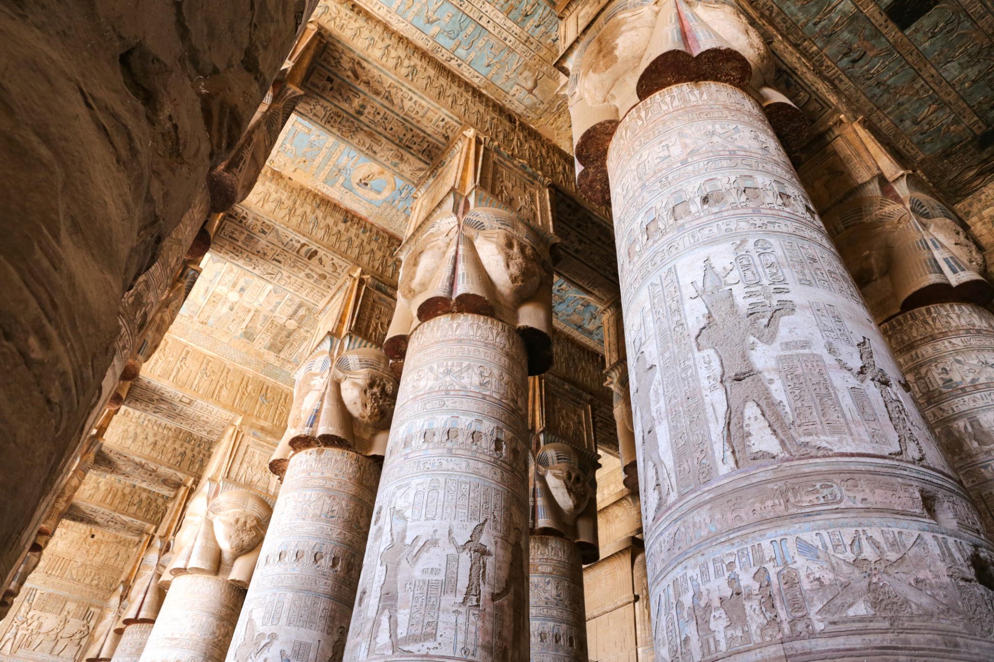 Cluster of intricately carved Hathor columns viewed from below at Dendera.
