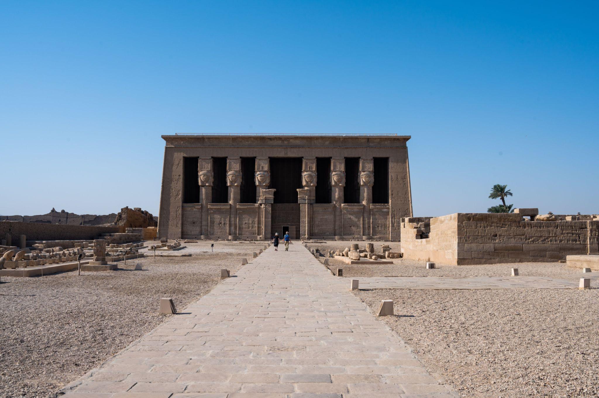 Front facade of Dendera Temple with six Hathor columns and processional causeway.