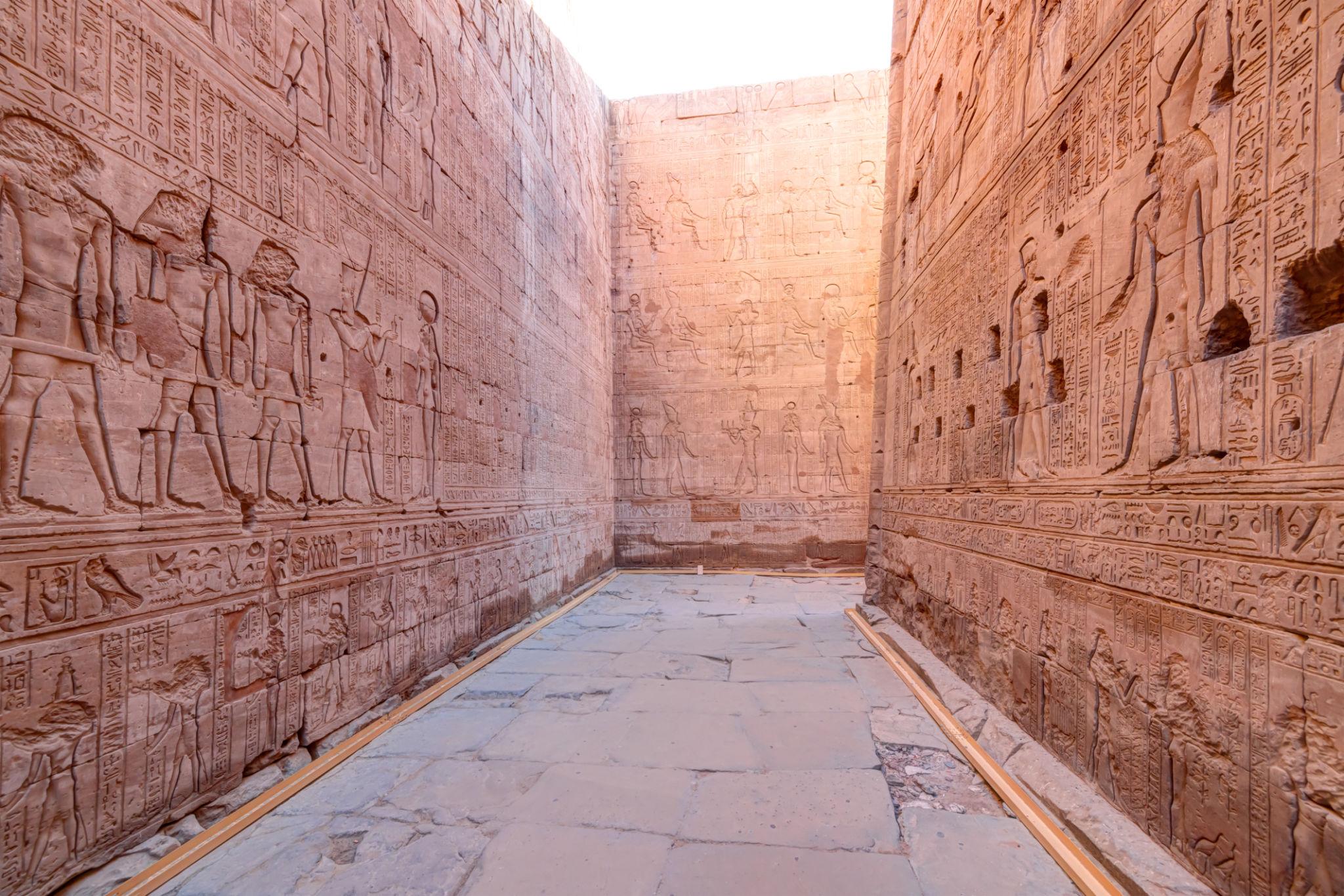 Stone ambulatory passage lined with reliefs around the Temple of Edfu sanctuary.
