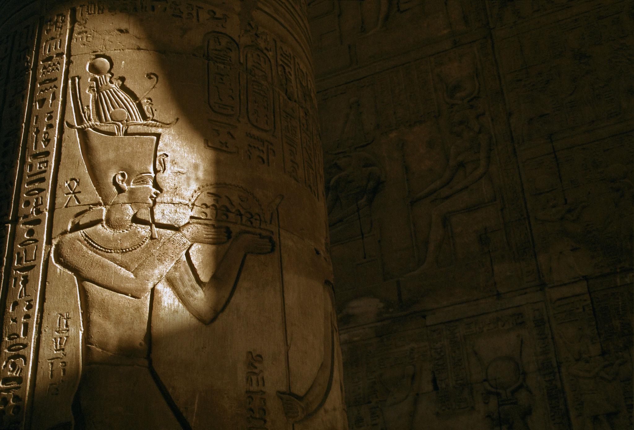 Sunlit relief of a crowned god carved on a column of the Temple of Edfu.