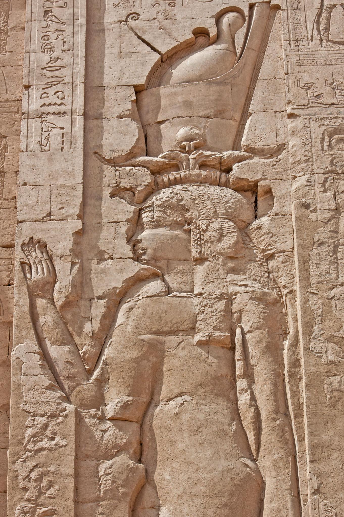Carved relief of a crowned Ptolemaic deity on the pylon of the Temple of Edfu.
