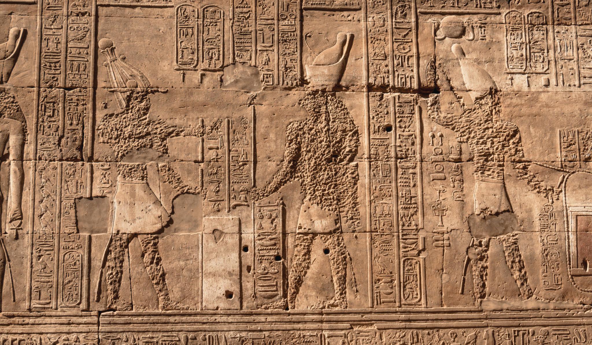 Relief frieze of priests making offerings carved on a wall at the Temple of Edfu.