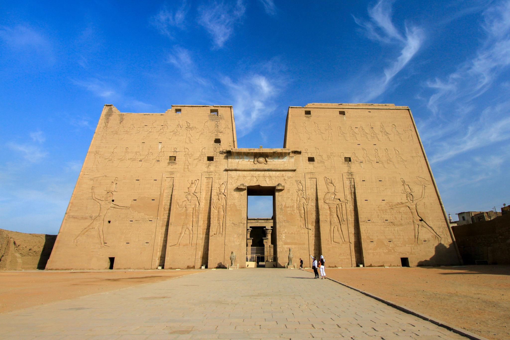 Front view of the towering twin pylon entrance of the Temple of Edfu.