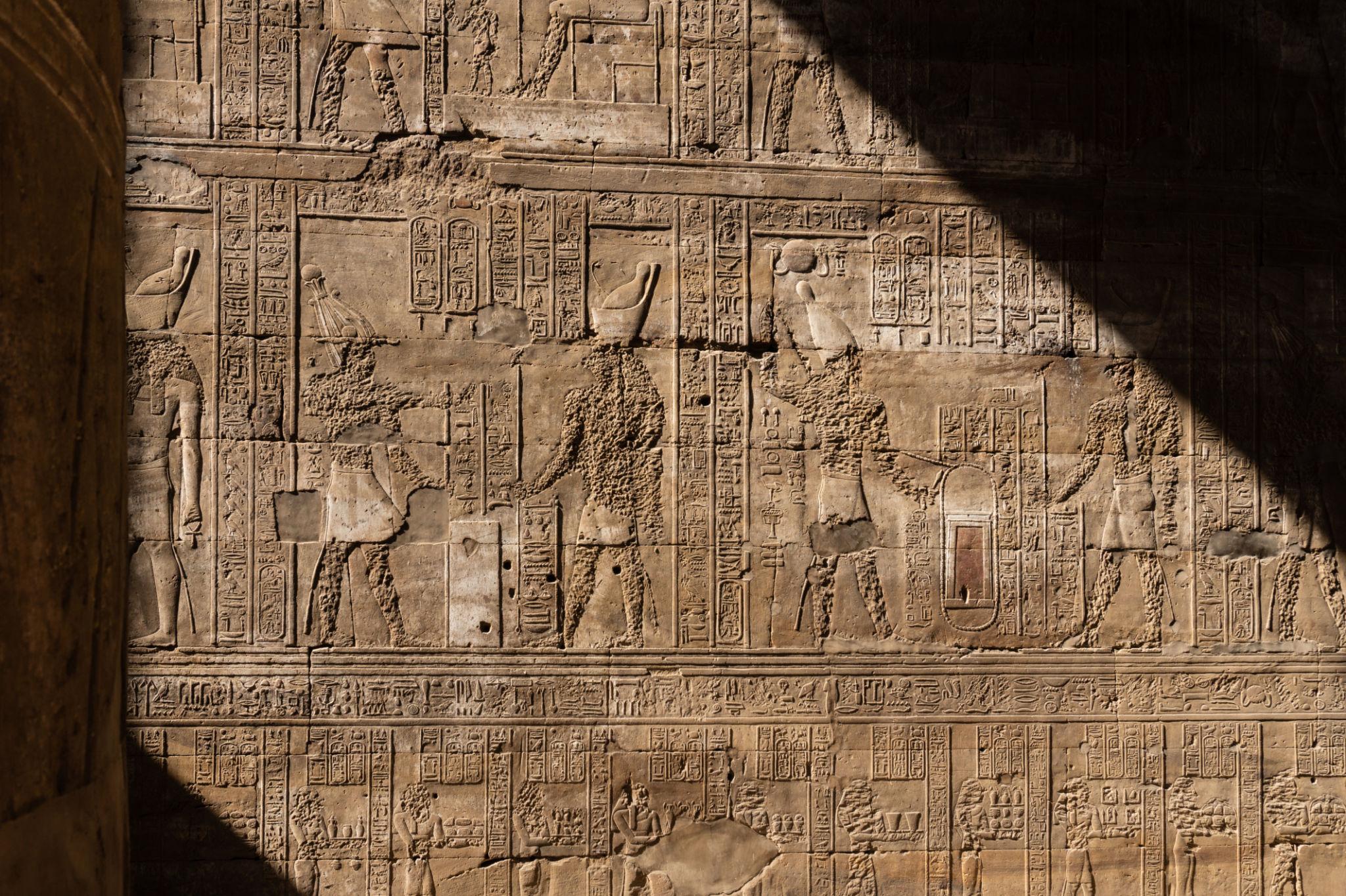 Sunlit relief panel depicting ritual offerings at the Temple of Edfu.