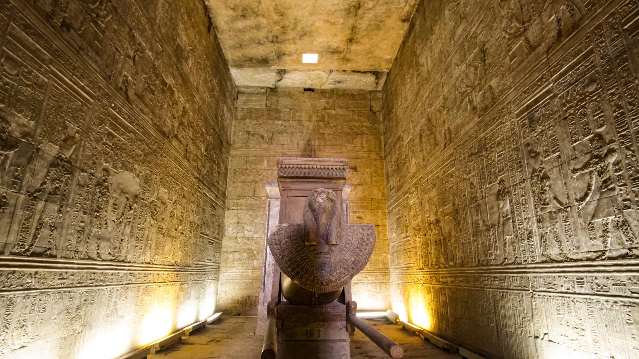 Central naos shrine illuminated inside the sanctuary of the Temple of Edfu.