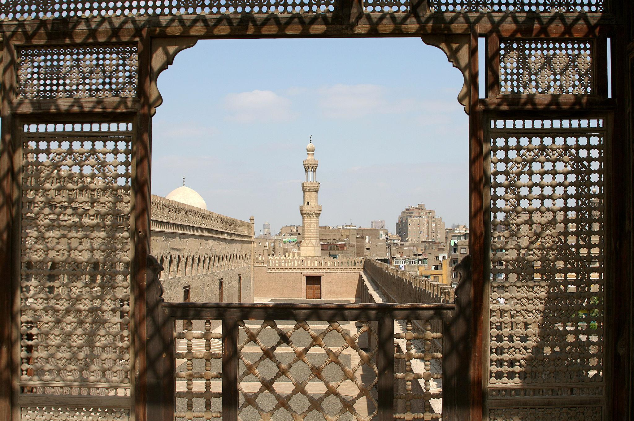 View of Ibn Tulun Mosque minaret framed by a carved mashrabiya screen at Gayer-Anderson Museum