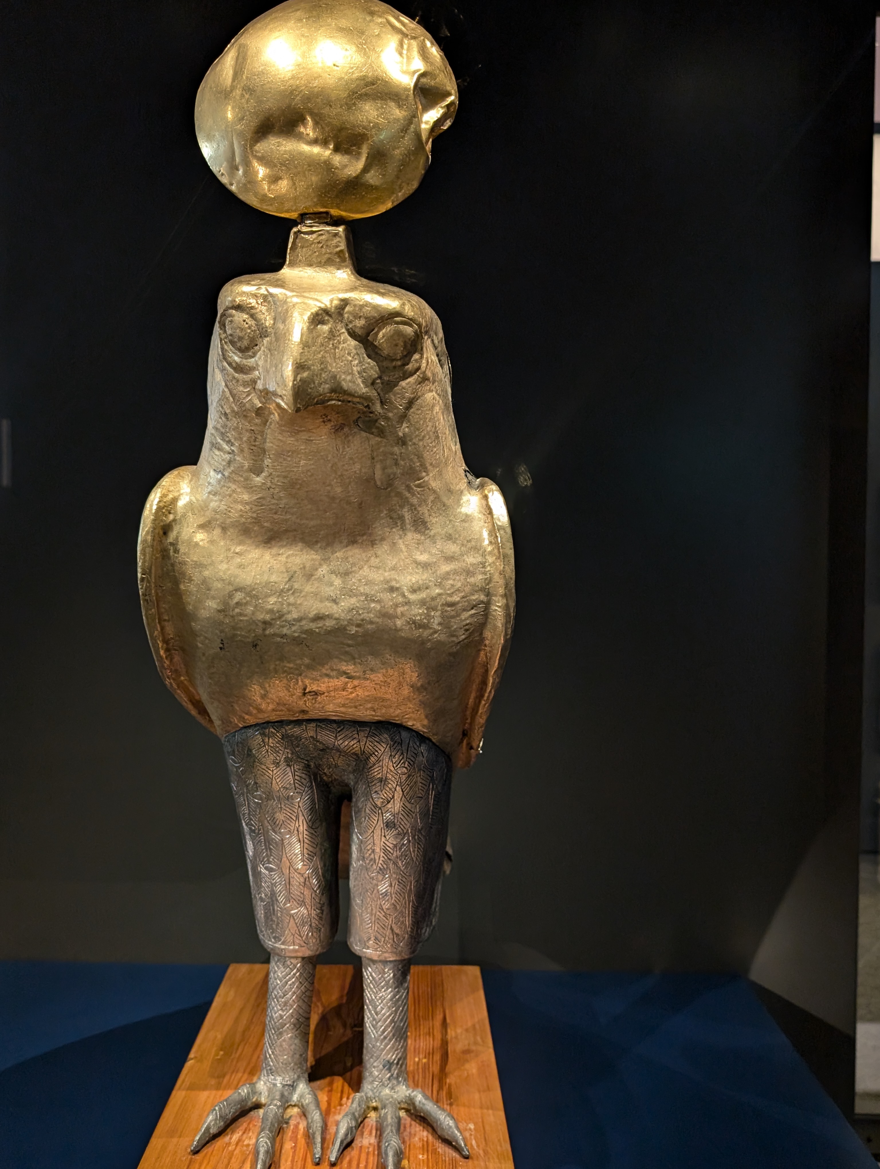 Ancient Egyptian gilded silver falcon statue of Horus with a golden sun disk head at NMEC