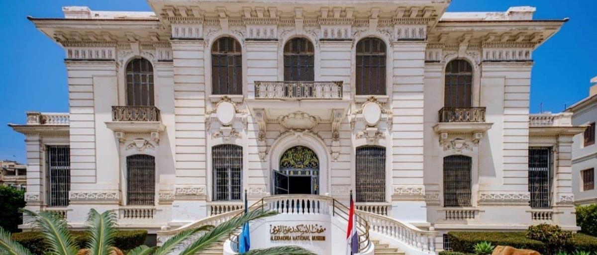 Ornate white neoclassical facade of the Alexandria National Museum with twin staircases