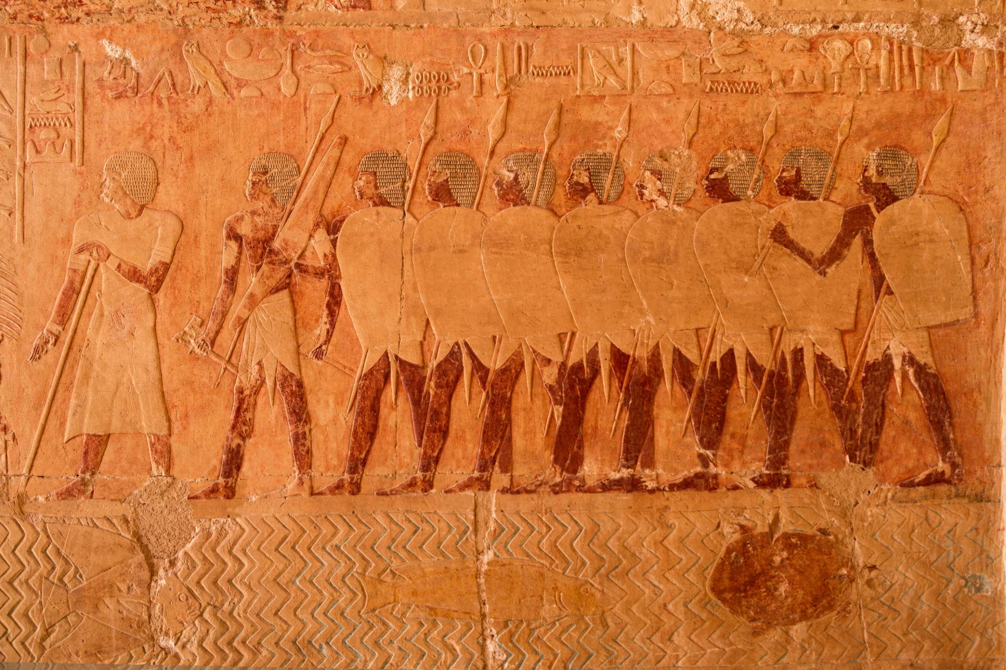 Painted relief depicting the famous Punt expedition porters carrying goods
