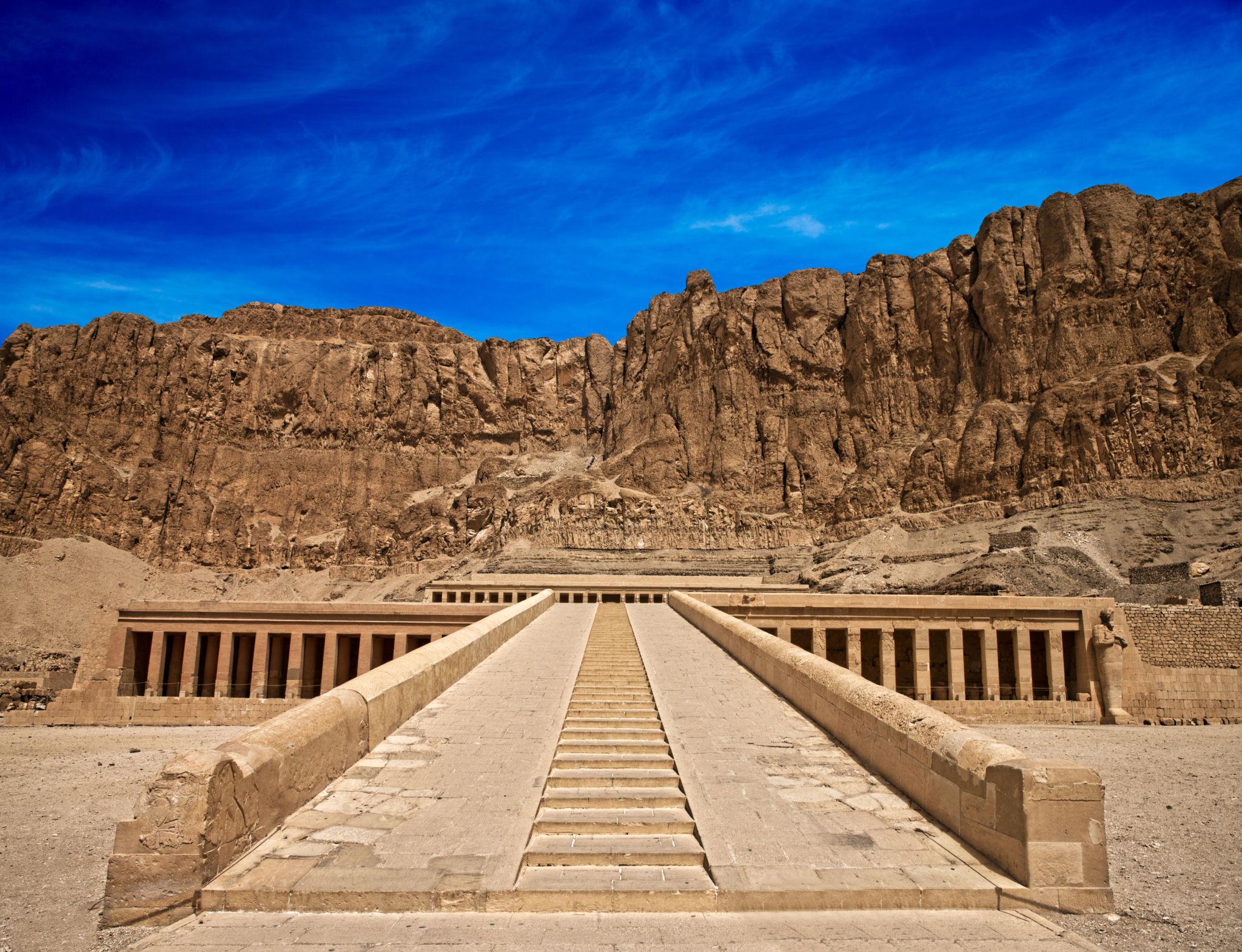 Processional ramp ascending to Hatshepsut Temple beneath dramatic Deir el-Bahari cliffs