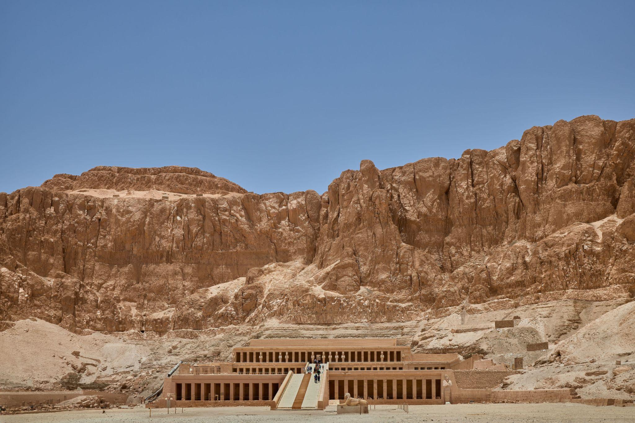 Panoramic view of terraced Hatshepsut Temple set against rugged limestone cliffs