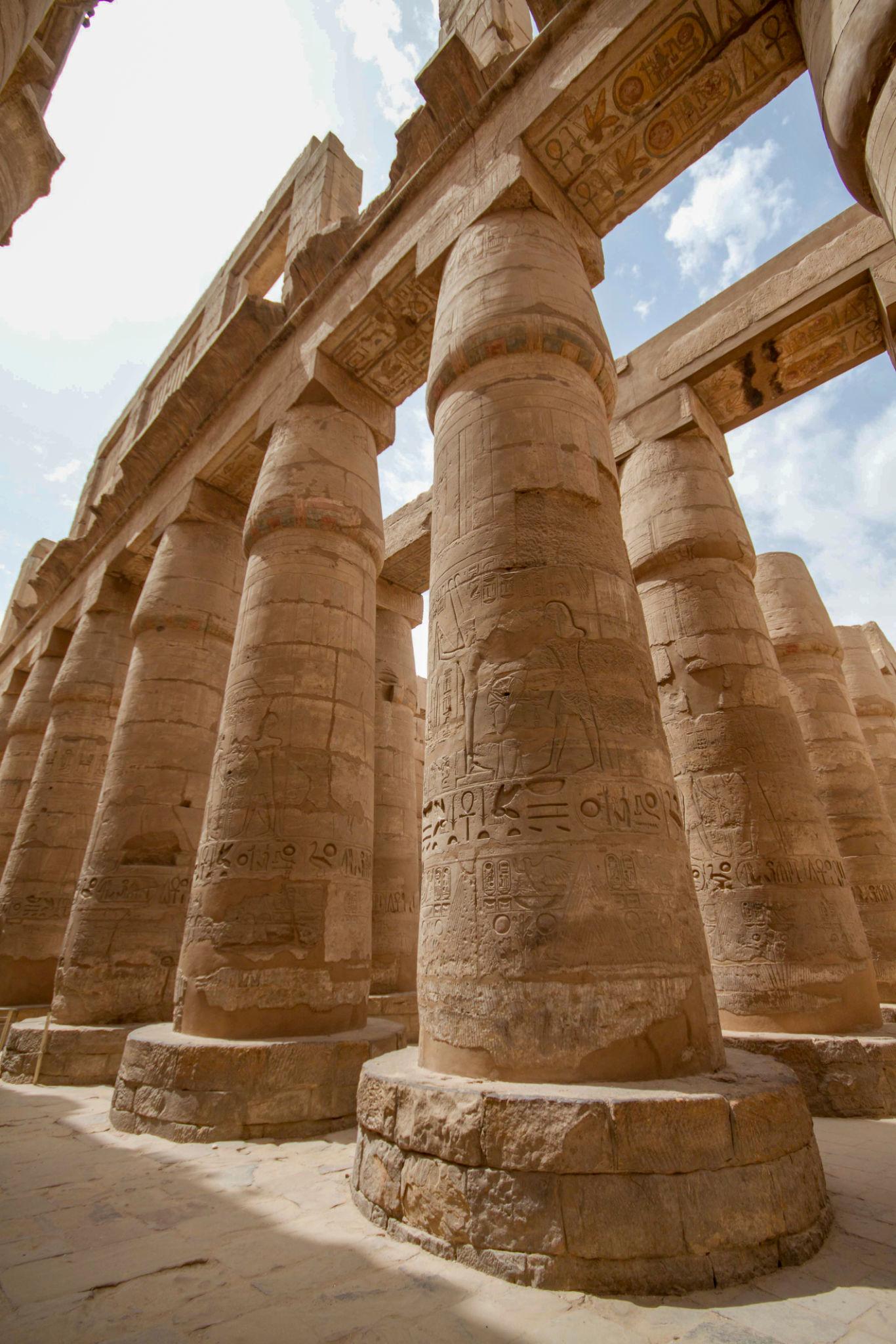 Colossal carved column bases rising in Karnak's Great Hypostyle Hall