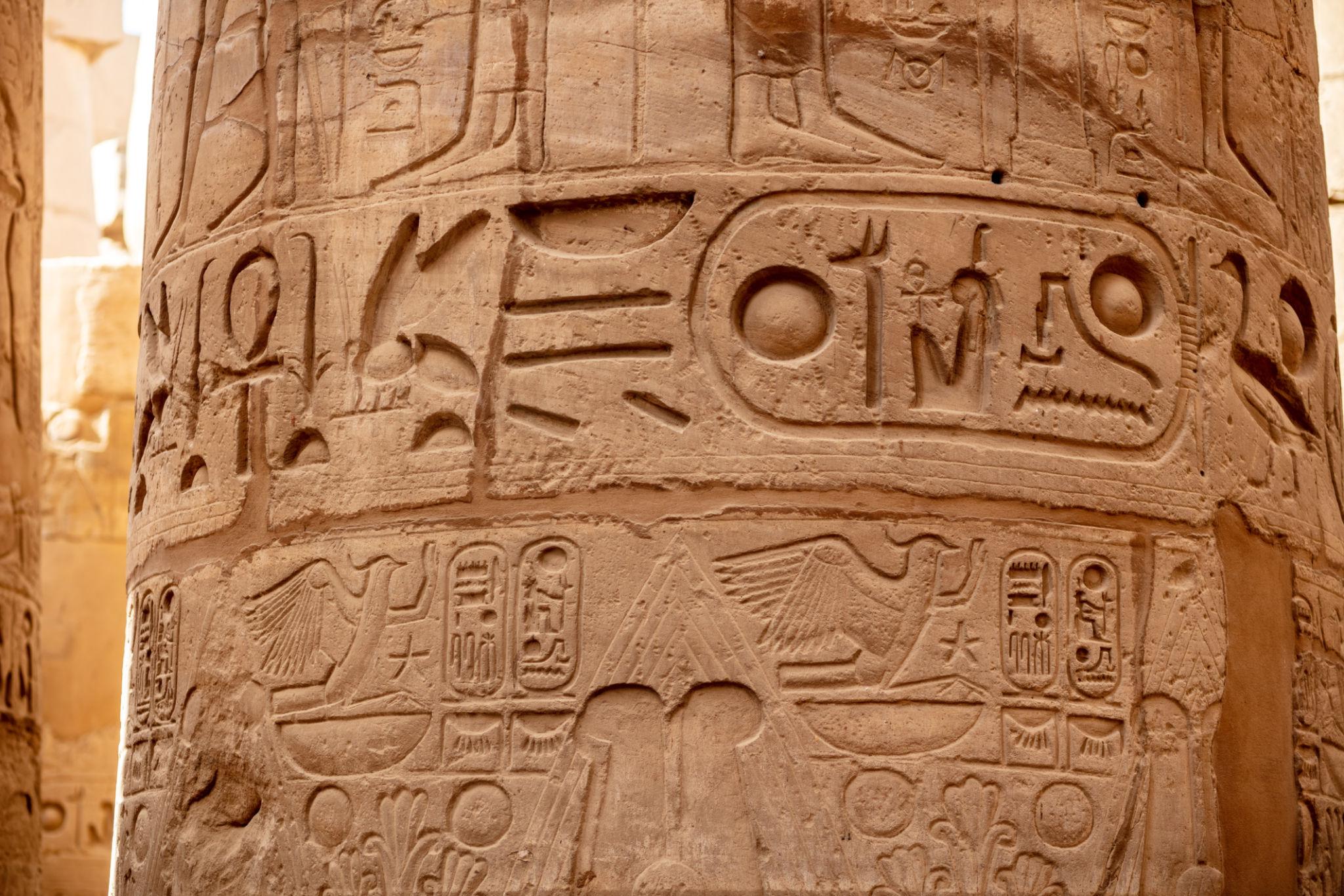 Close-up of carved hieroglyphs and royal cartouche on a Karnak column