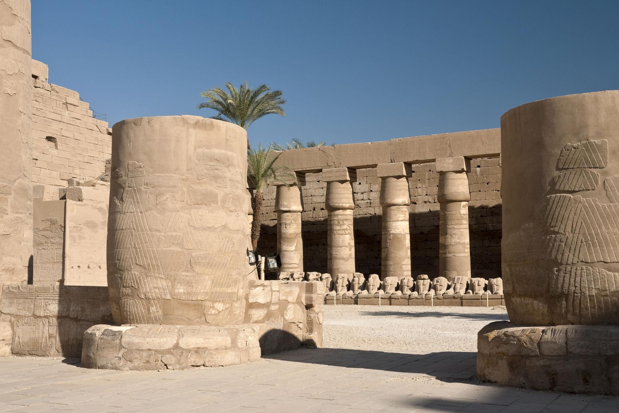 Massive column bases and ram-headed statues in the court of Ramesses III