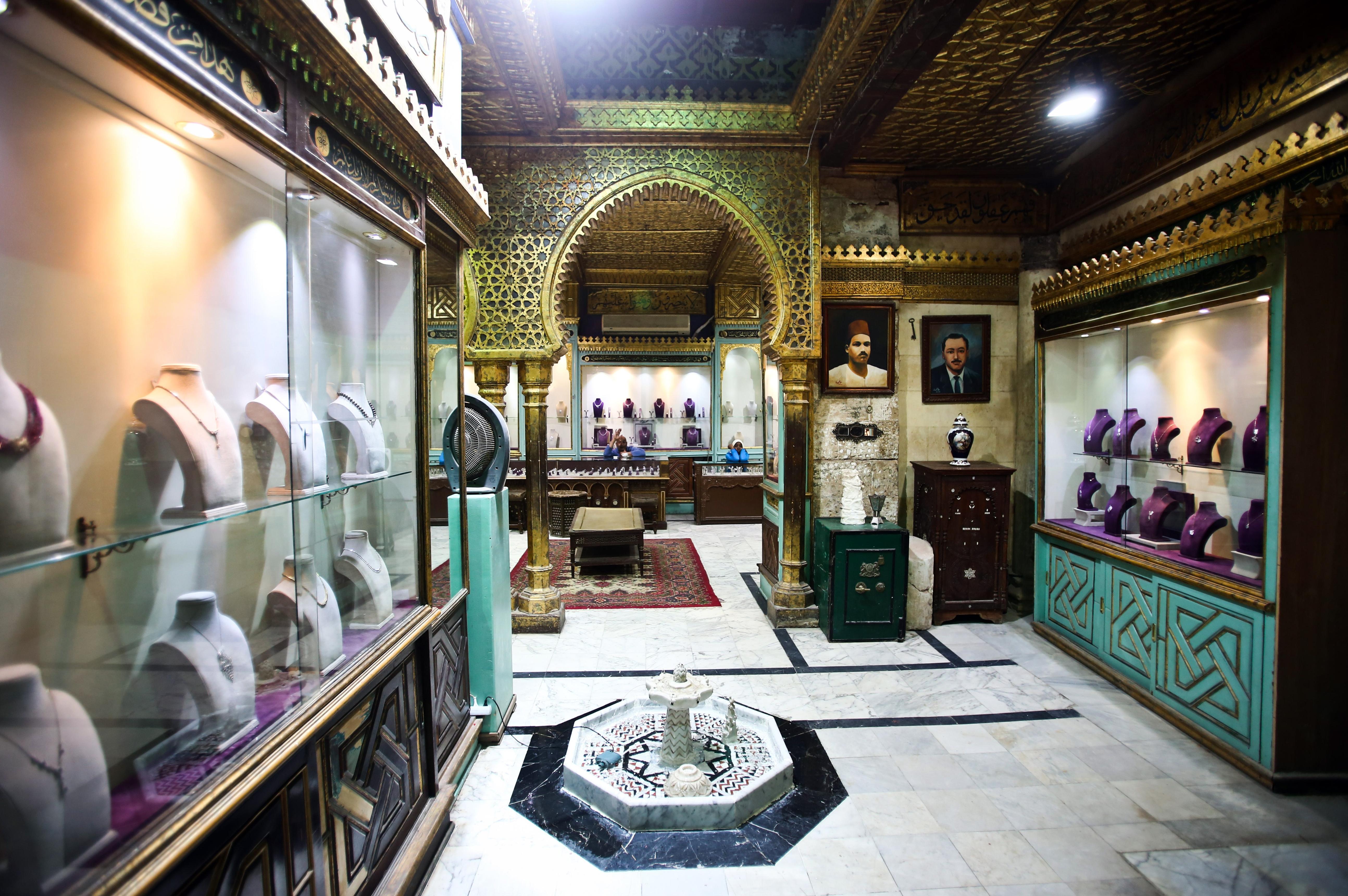 Lavishly decorated Moorish jewelry shop with glass display cases and a marble fountain.