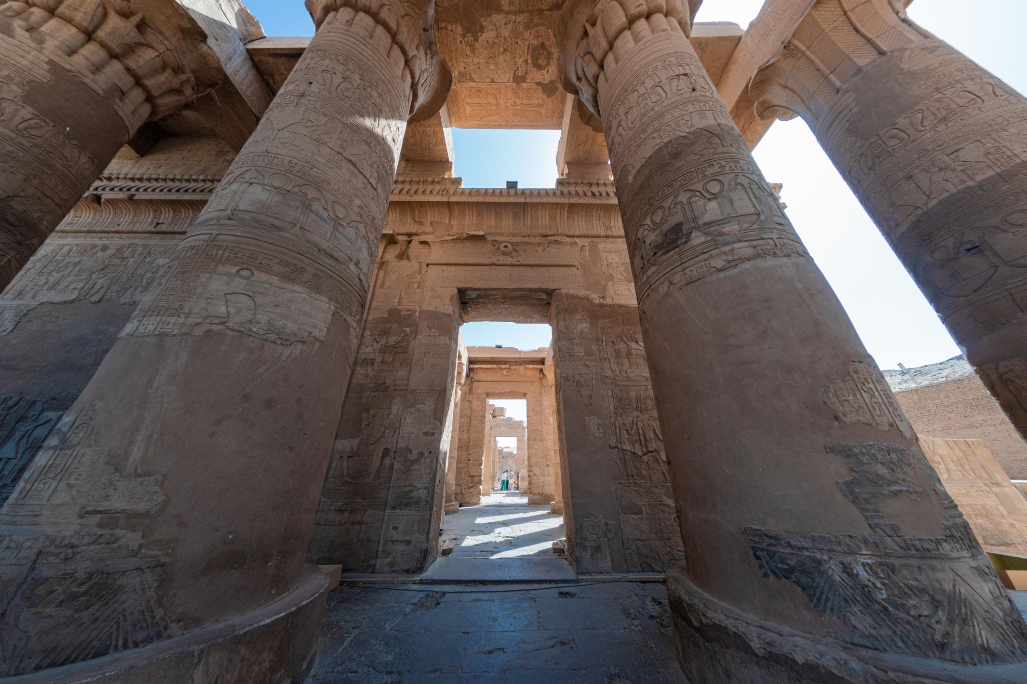 Wide-angle view of massive carved columns lining the forecourt of Kom Ombo Temple.
