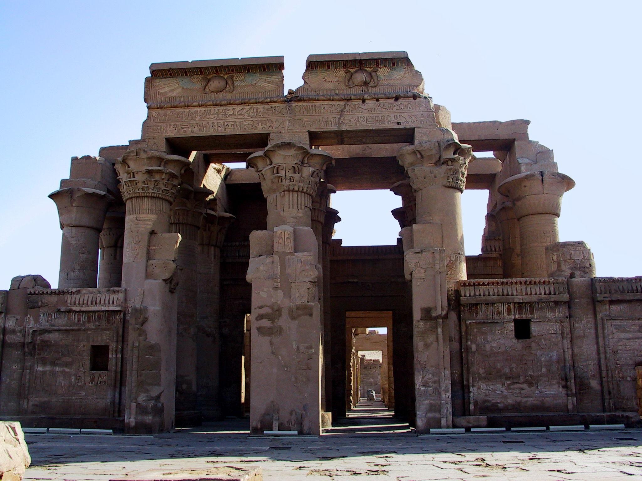 Main entrance pylon of Kom Ombo Temple with winged sun disks and lotus columns.