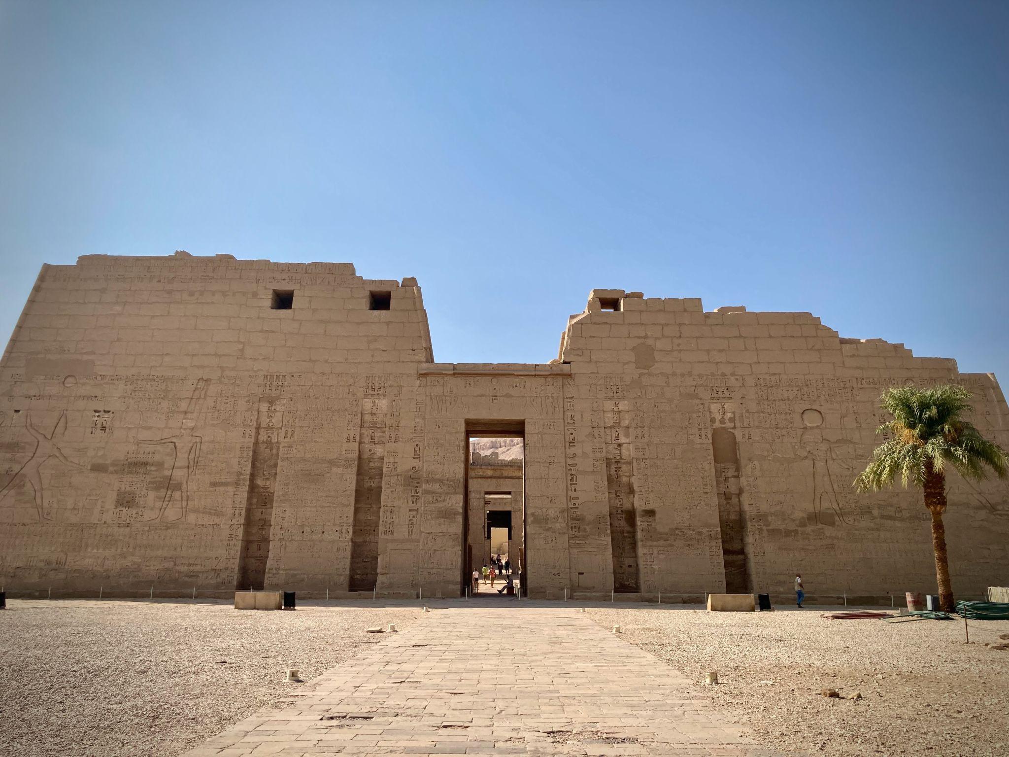 Frontal view of the massive first pylon of Medinet Habu temple in Luxor.