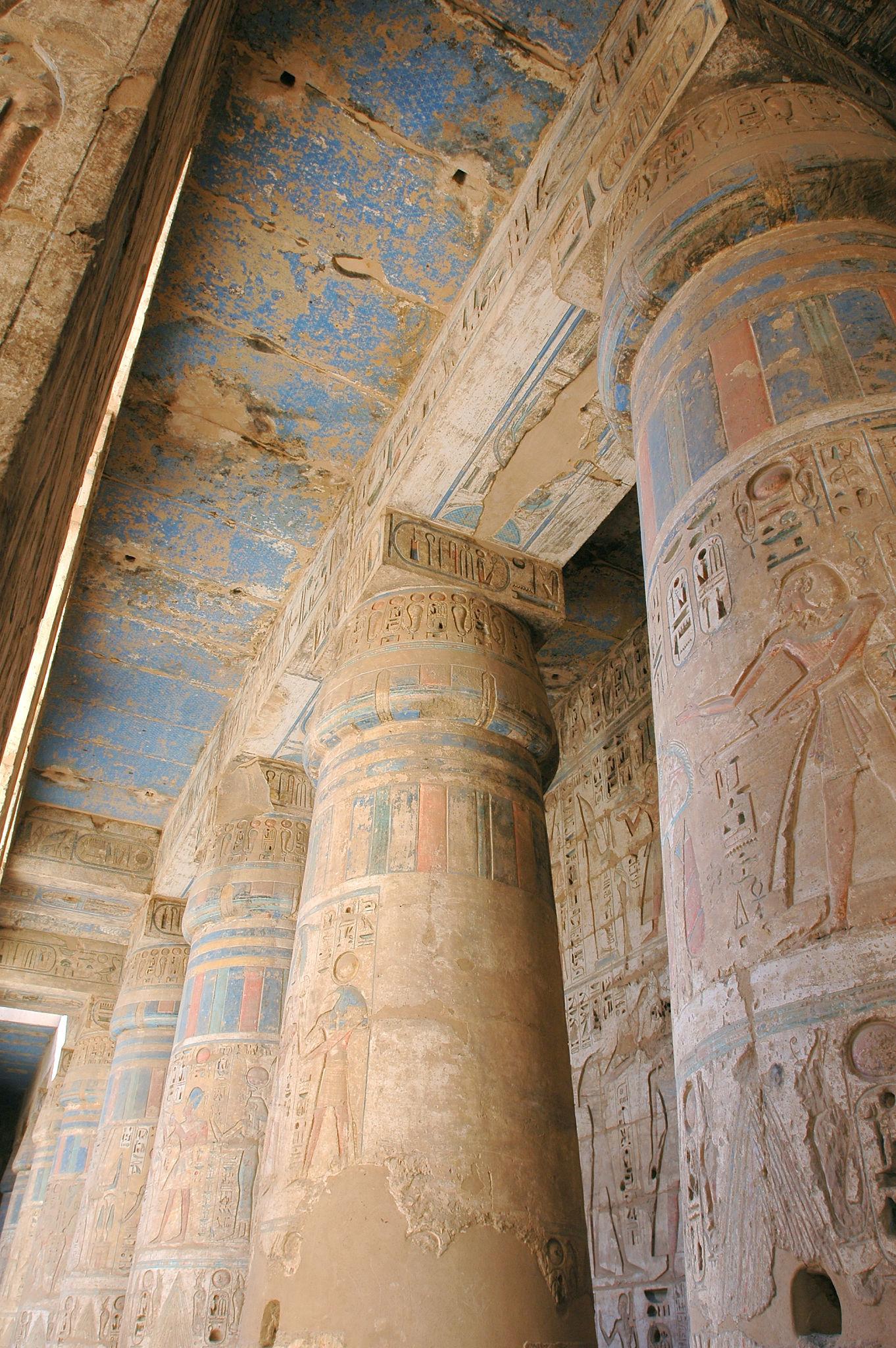 Colorful painted ceiling and column reliefs in the second court of Medinet Habu.