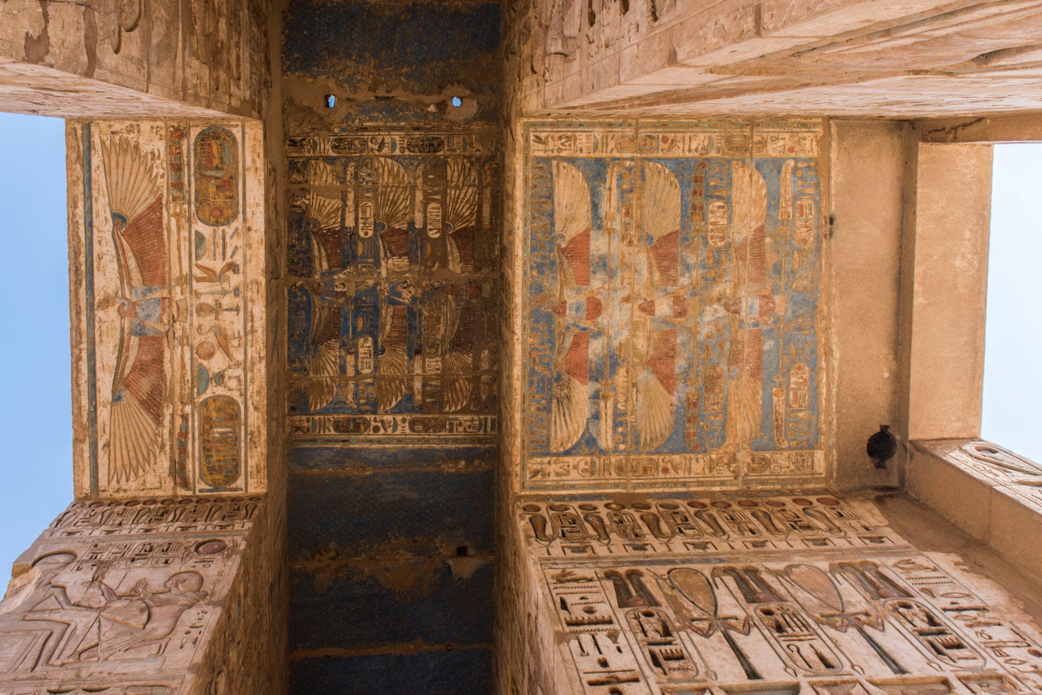 Painted ceiling with Nekhbet vulture motifs and winged sun disc at Medinet Habu.