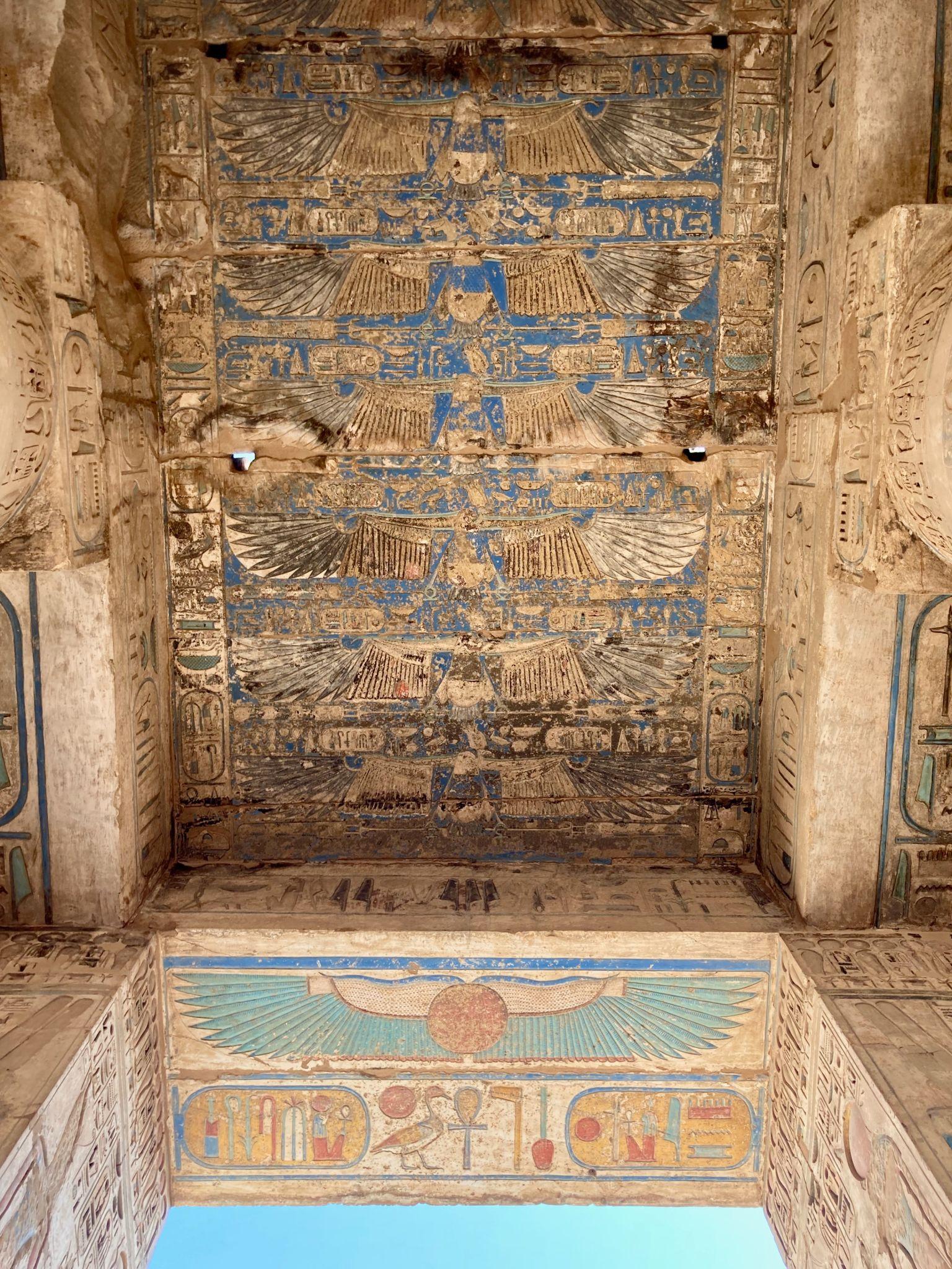 Painted ceiling showing rows of winged goddesses protecting the royal cartouches.