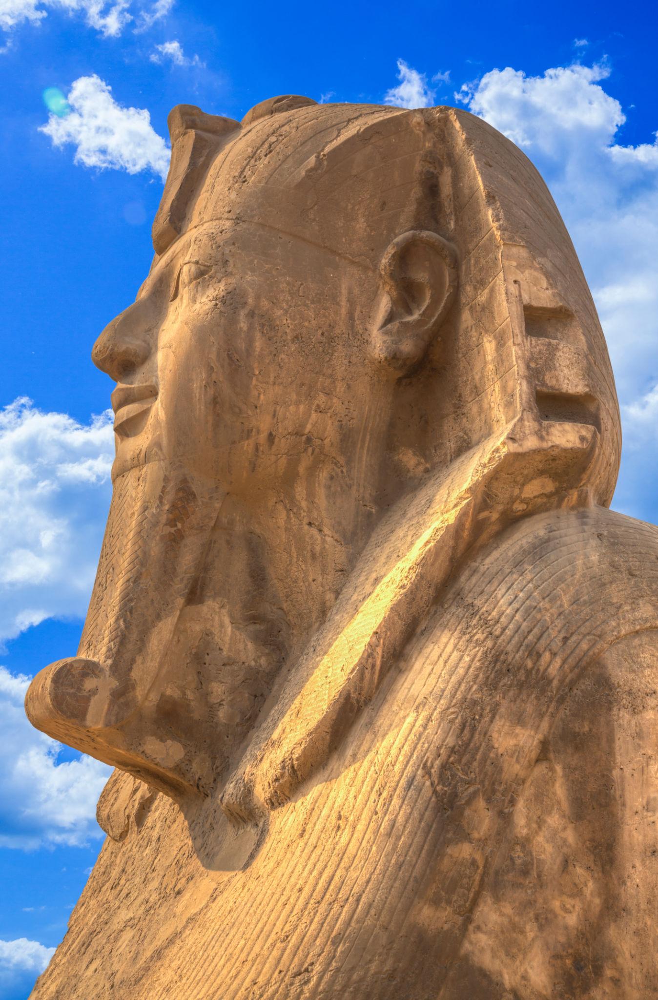 Alabaster Sphinx of Memphis profile against a bright blue cloudy sky