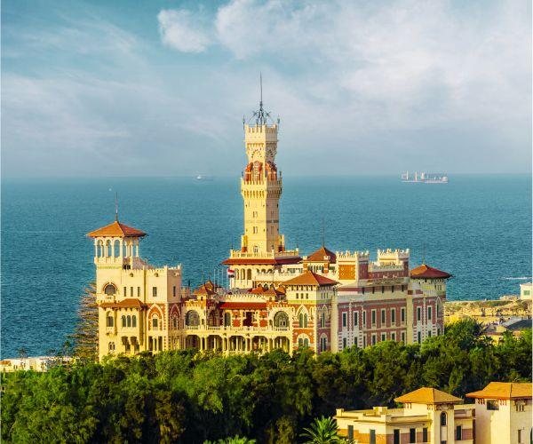 Montaza Palace rising above green gardens beside the Mediterranean sea