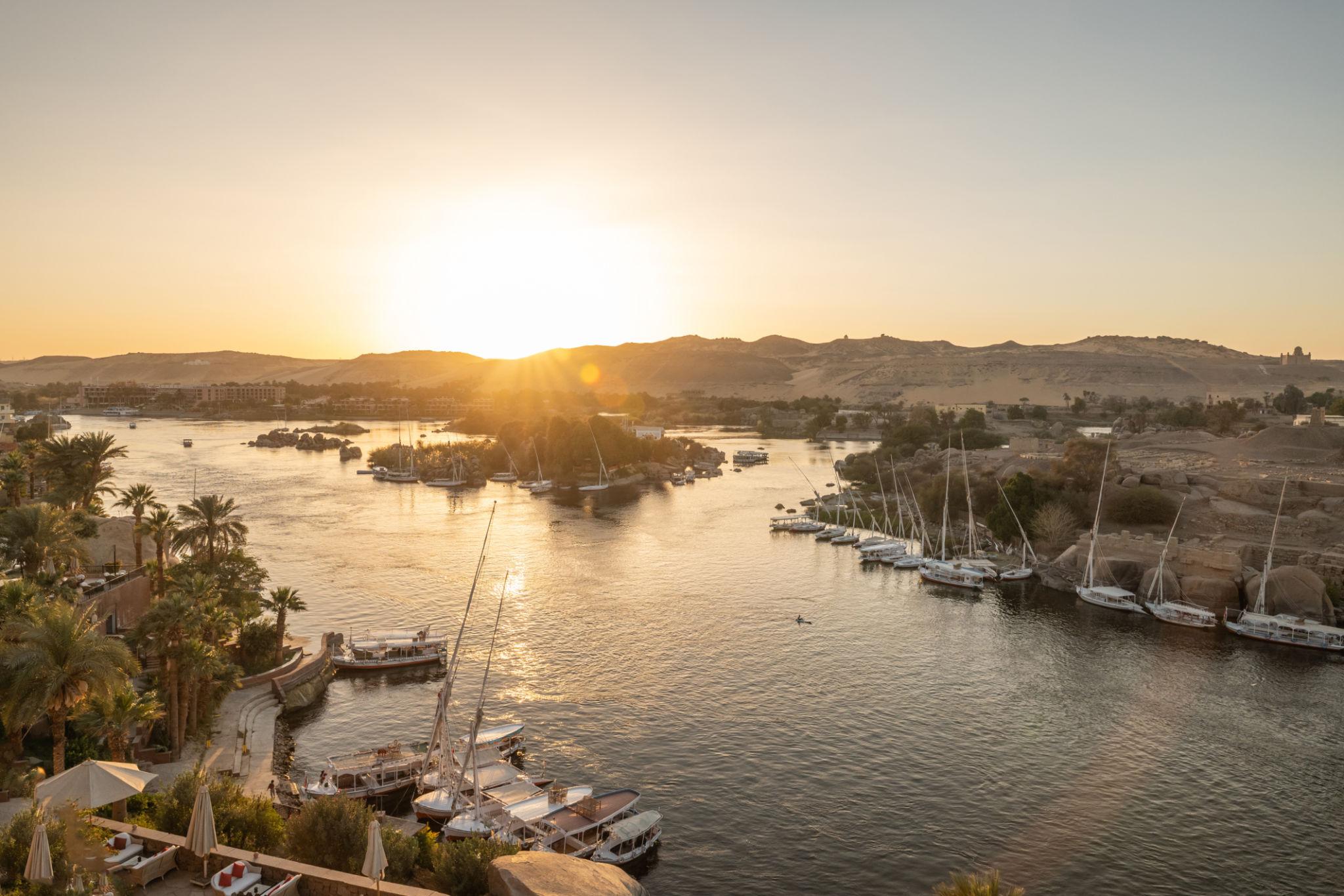Aerial sunset view of feluccas moored around Elephantine Island on the Nile at Aswan.