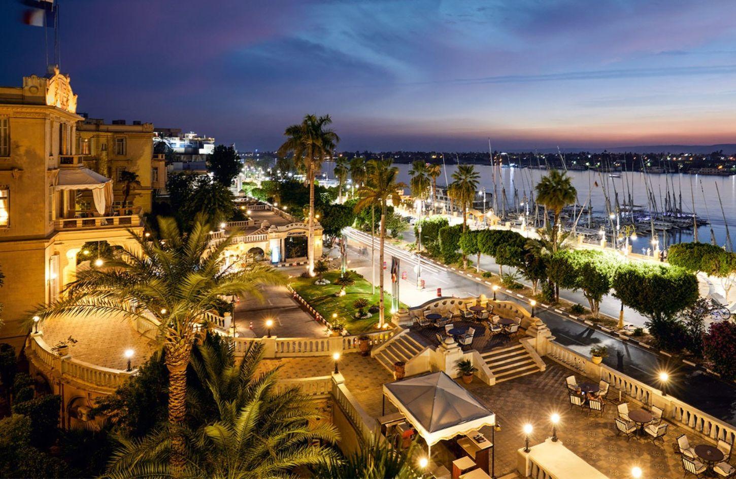 Evening view over a riverside hotel terrace and Nile marina in Luxor