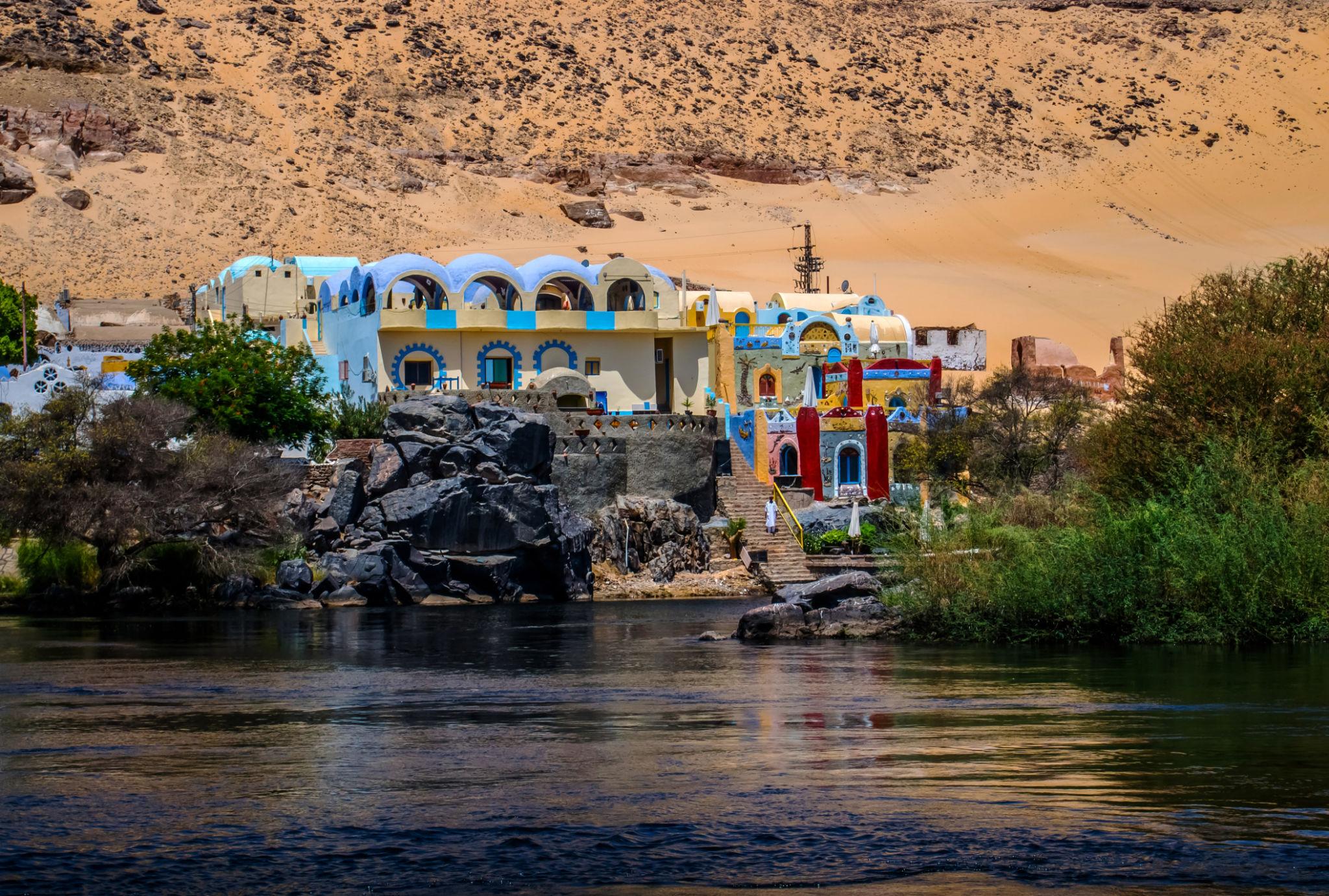 Colorful Nubian village with domed buildings on the rocky banks of the Nile River