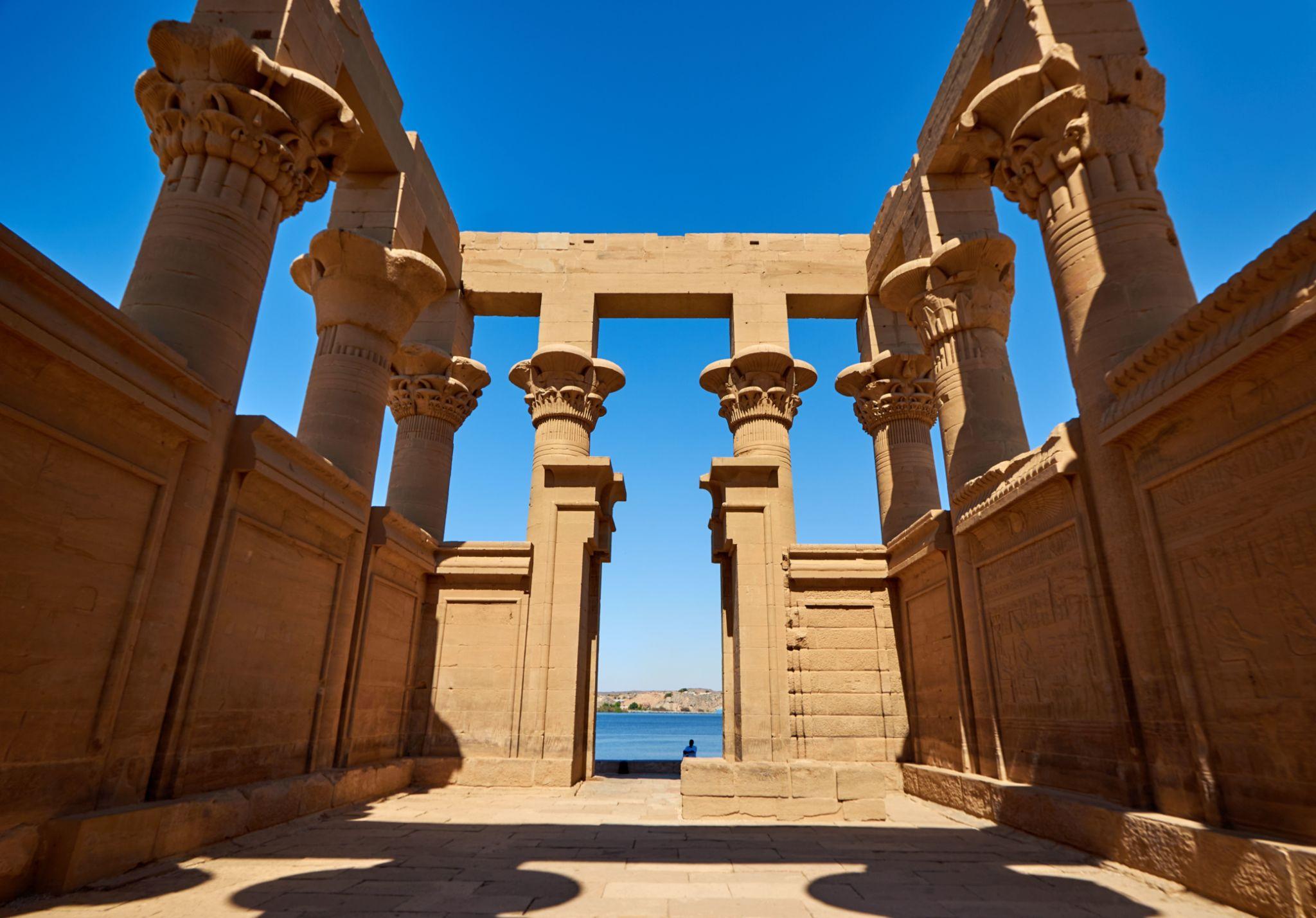 Ancient Egyptian columns framing a view of the Nile at Philae Temple of Isis