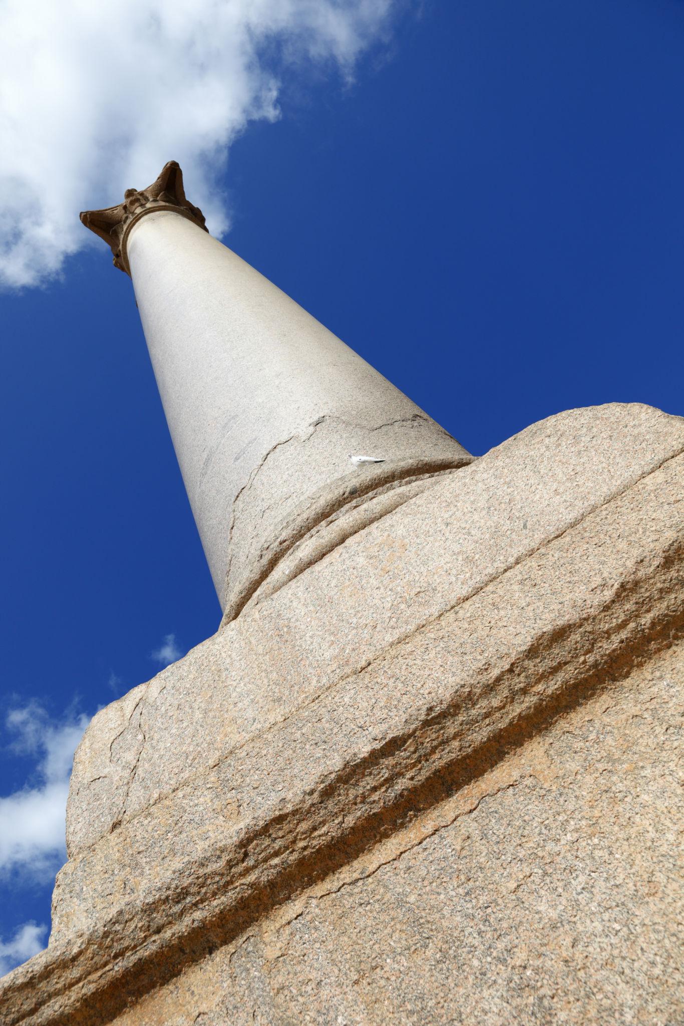 Dramatic upward view of Pompey's Pillar from its granite base toward the Corinthian capital