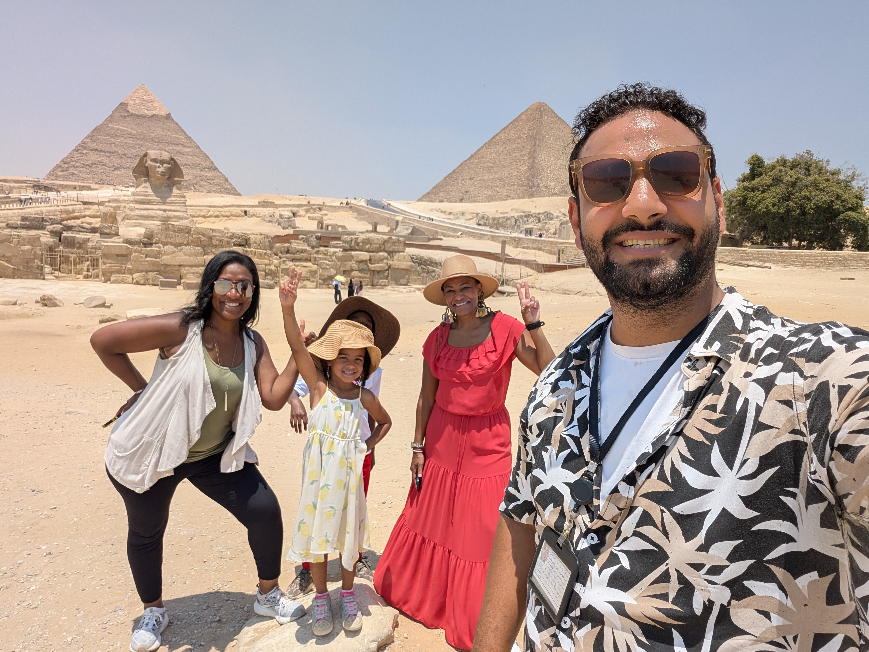 Family taking a selfie with the Sphinx and pyramids of Giza behind them