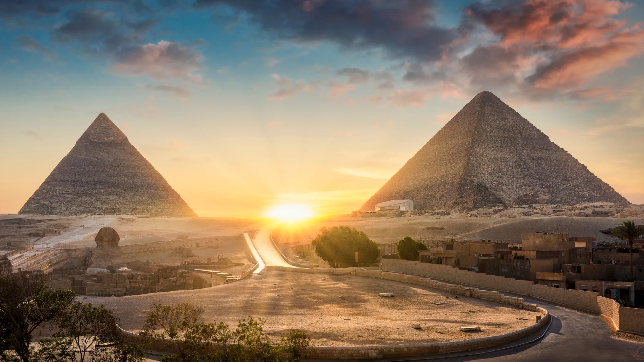 Golden sunset between Khufu and Khafre pyramids over the Giza plateau
