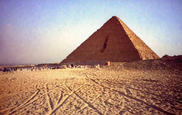 The Red Pyramid of Dahshur rising from sandy desert with visitors gathered at its base
